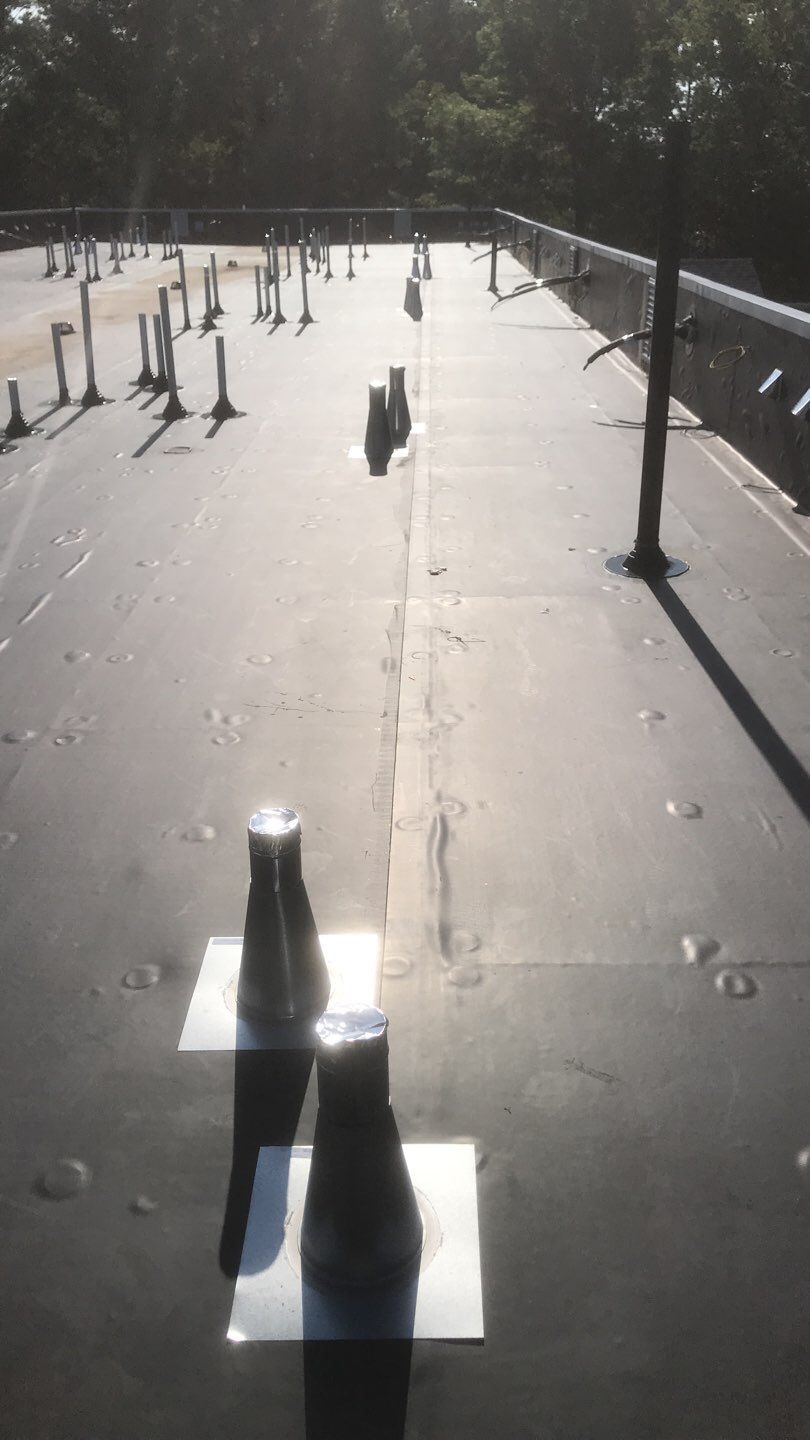 Commercial Roofing Installation using EPDM with white gutters by A Plus Exterior