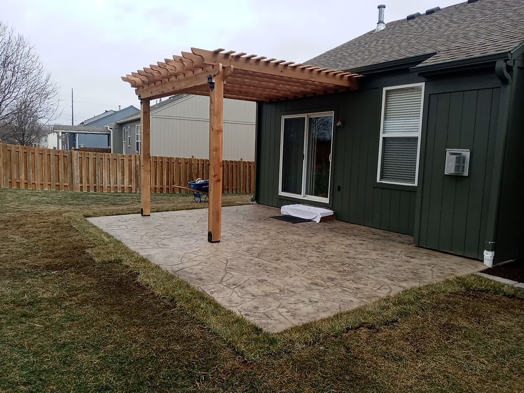 Back Yard Stamped Patio and Pergola by LAND ESCAPES LLC
