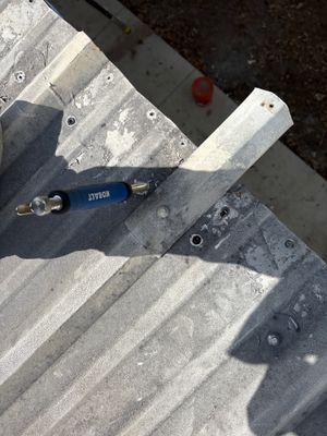 Close up of metal roof panel with drill