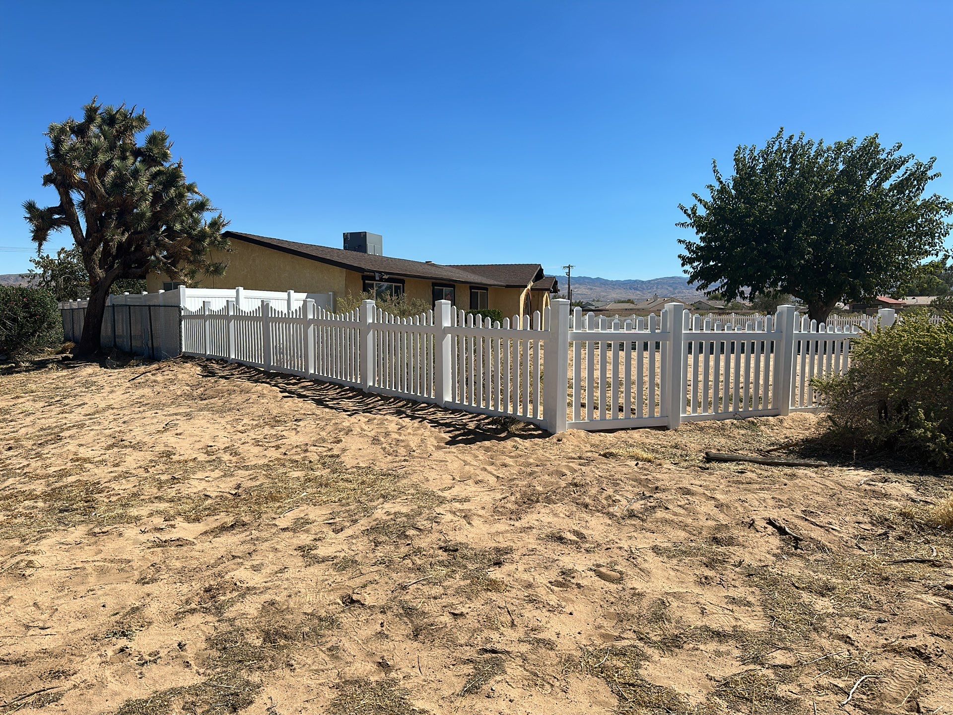 White picket fence  by Fence Guys Inc. 