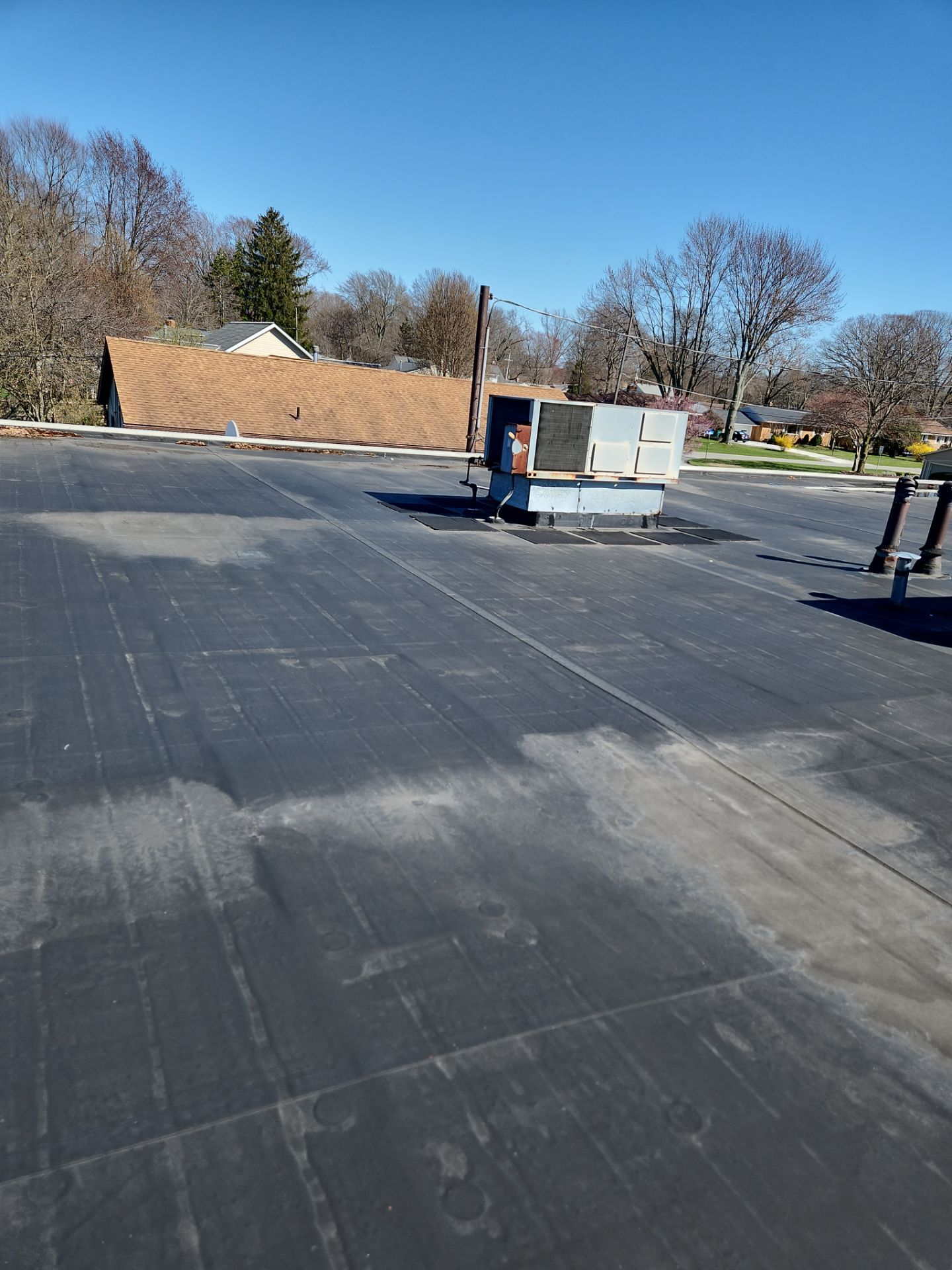 Commercial Roofing Repair using UniFlex Silicone Roof Coating on KinderCare Learning Center by 3 Daughters Construction 