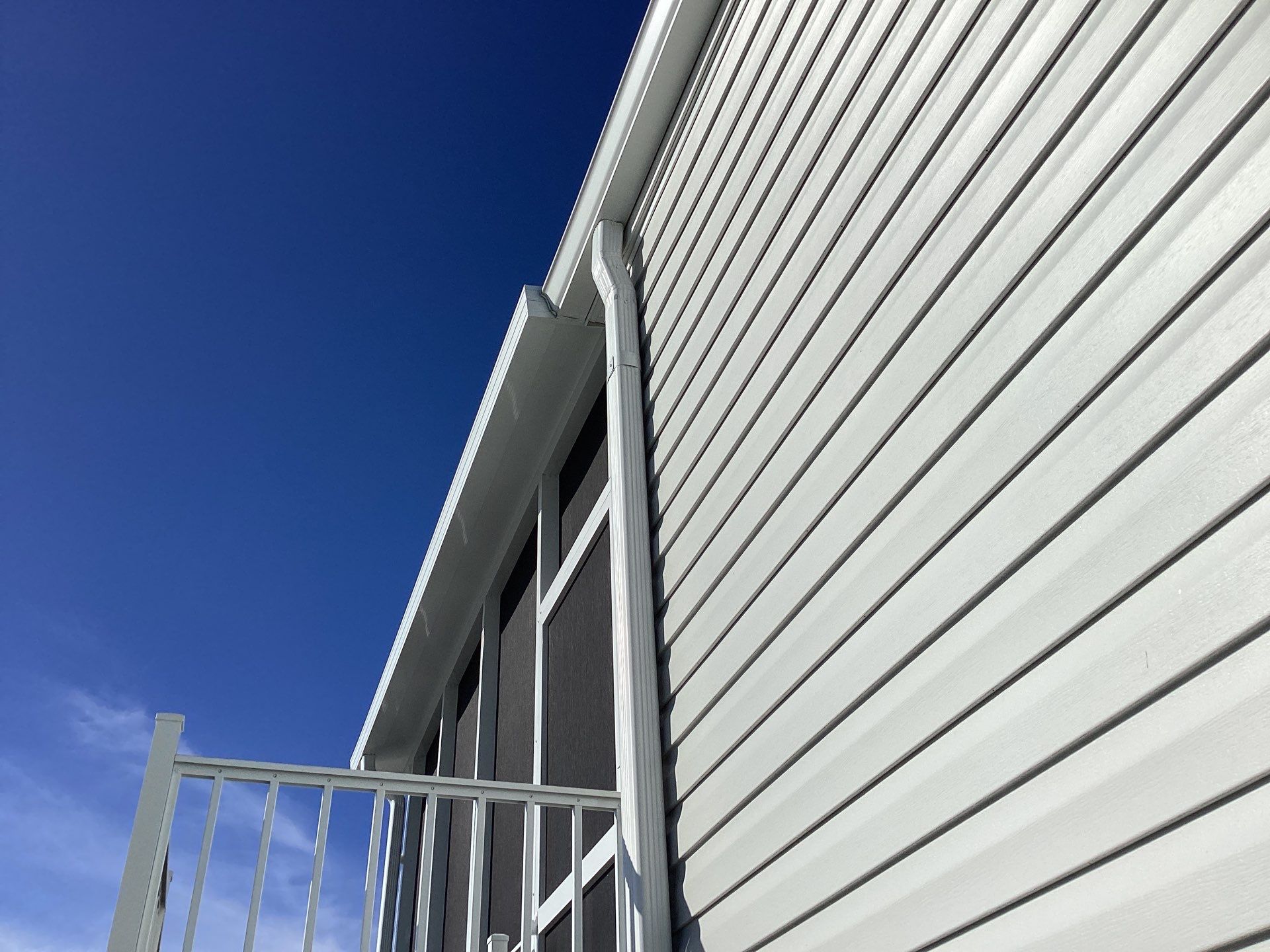 White Downspouts Installation in St. James City by Gutter Professors