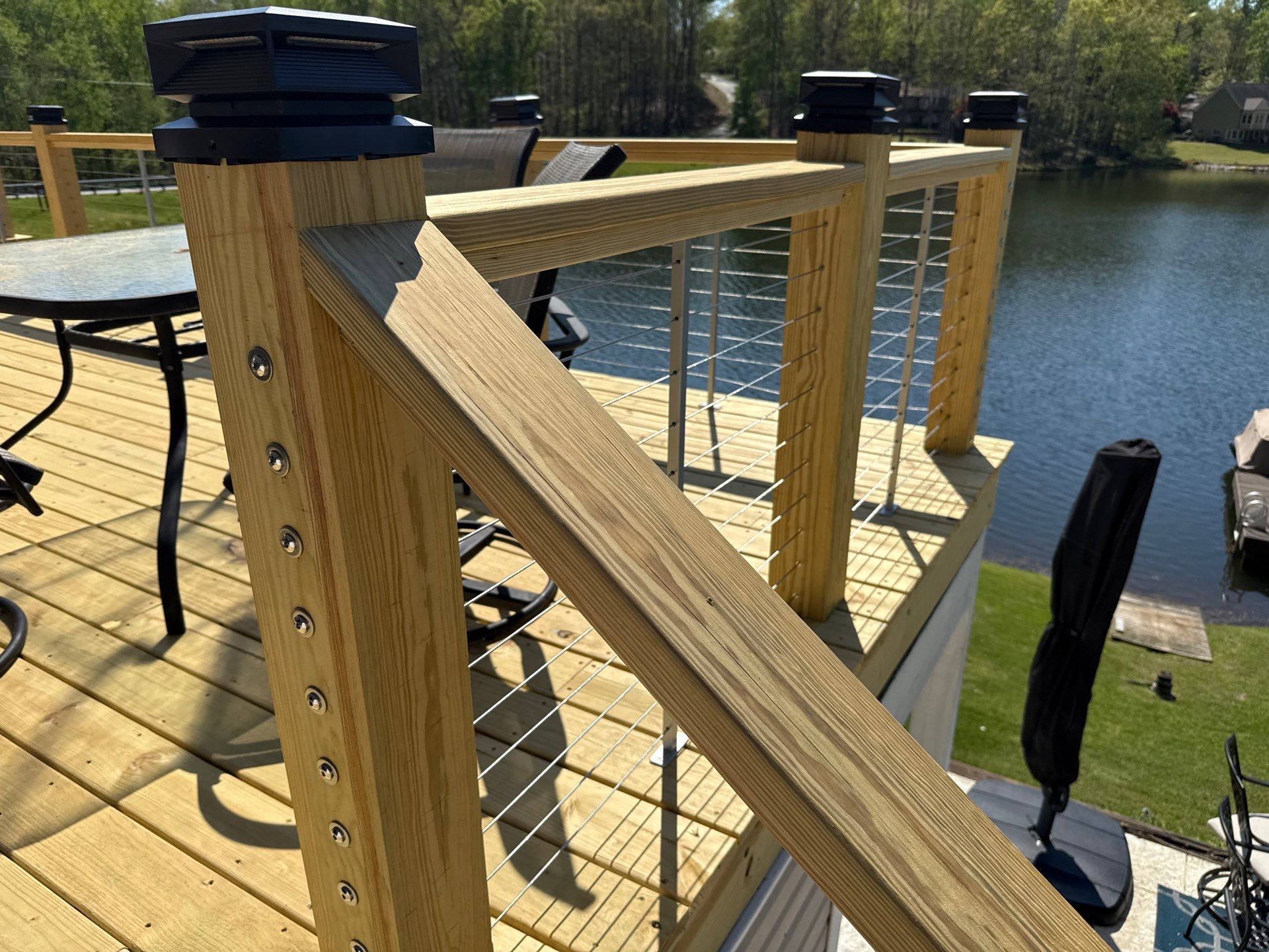 Cumming, GA Lake House Deck Resurface and Extension using Pressure Treated Pine and Skyline Cable Railing by Nelson Exteriors 