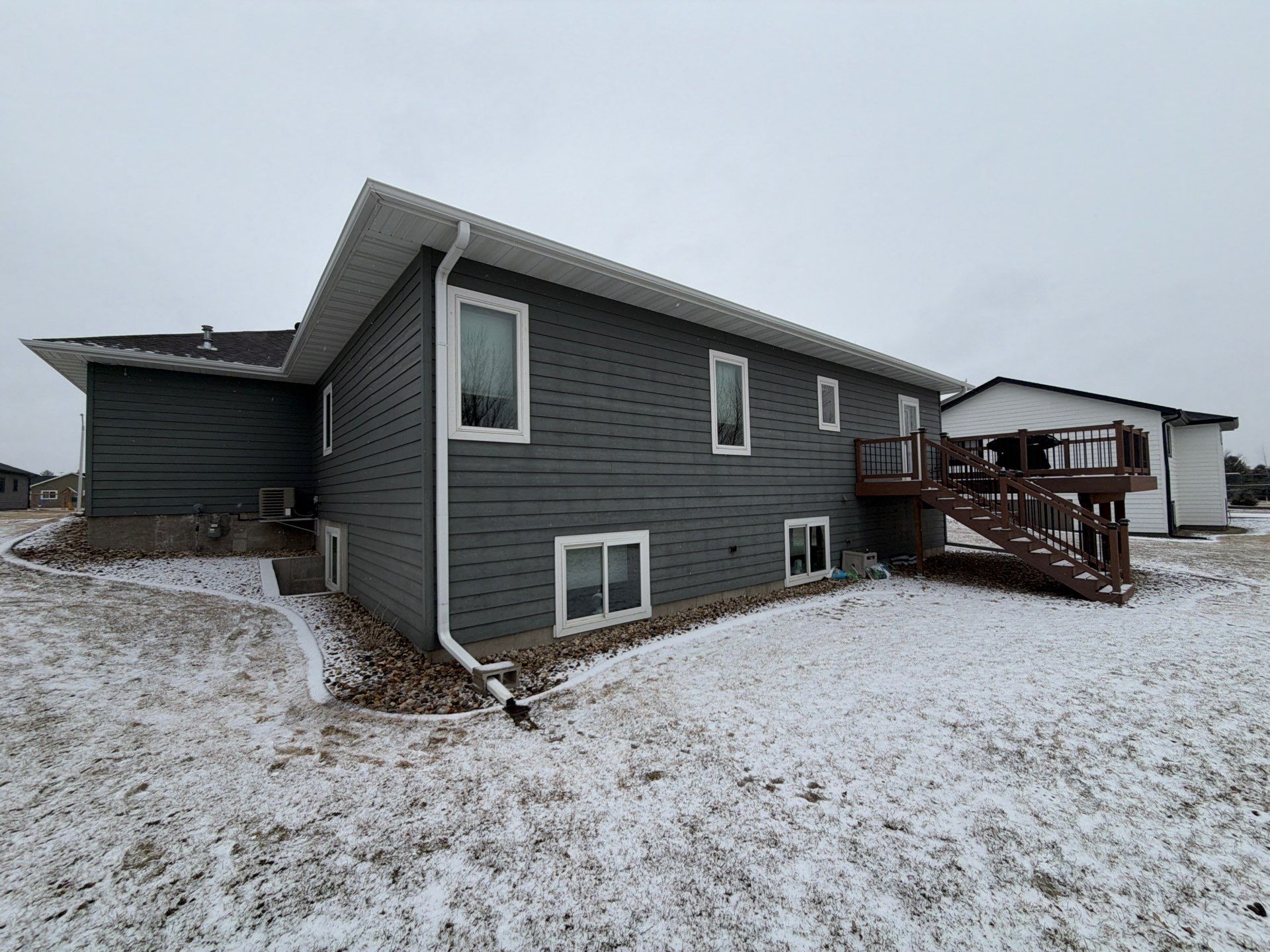 Madison Exterior Remodel with Dark Gray Siding and Stone Accents by Select Painting, Coatings & Garage Cabinets