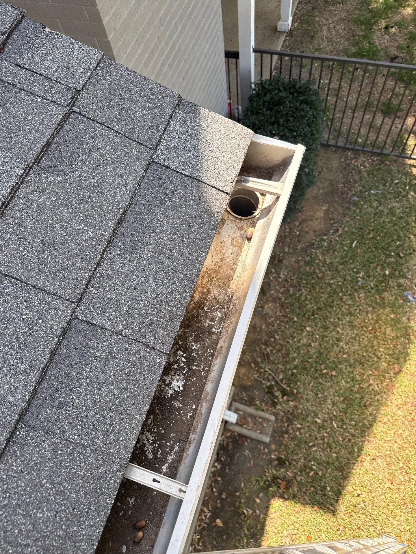 HOA gutter cleaning in Flower Mound & Lewisville, TX, after  photo showing full gutters.