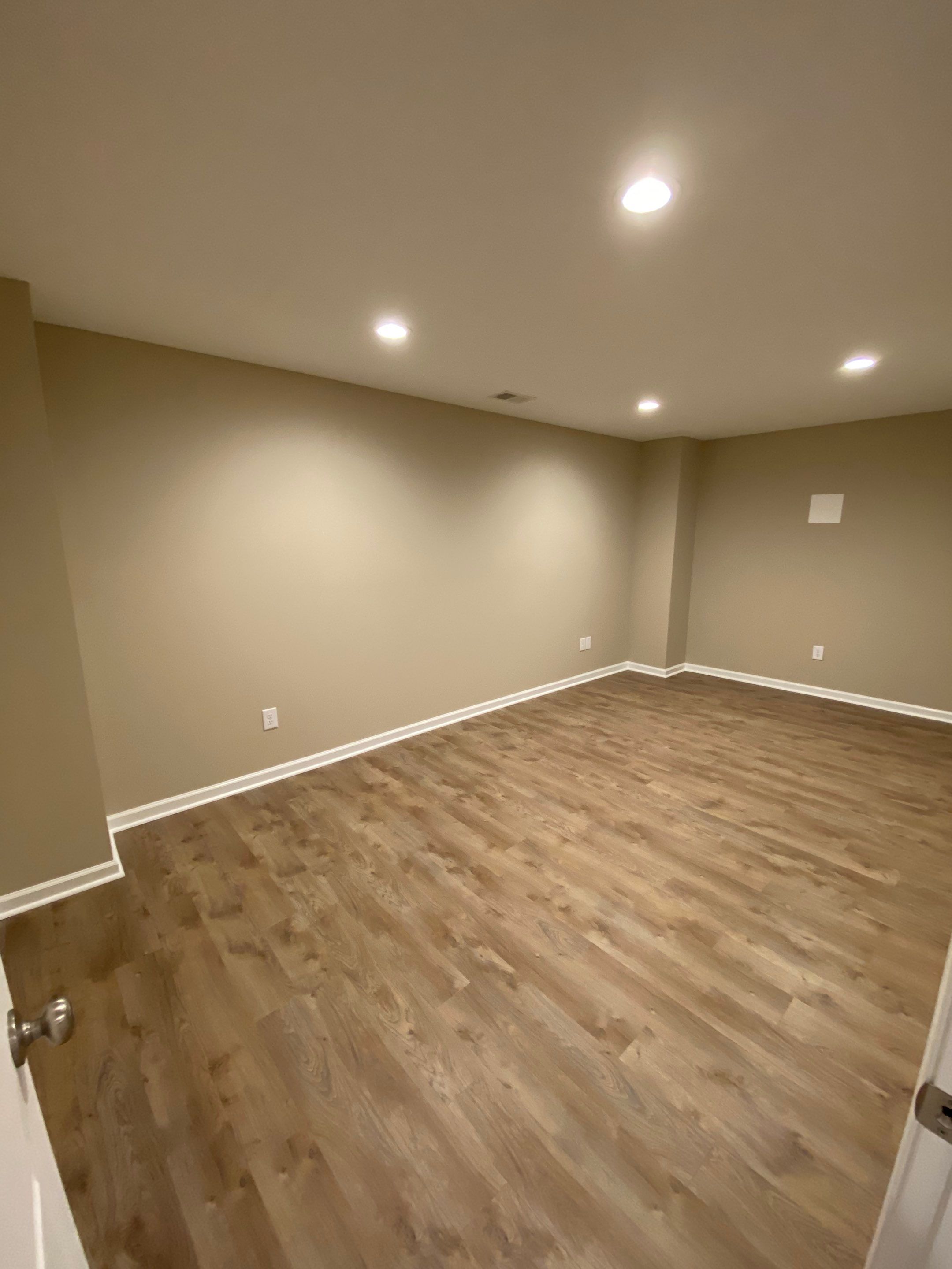 Acworth Basement Transformation With Wet Bar and Stone Fireplace by Swift Home Renovations