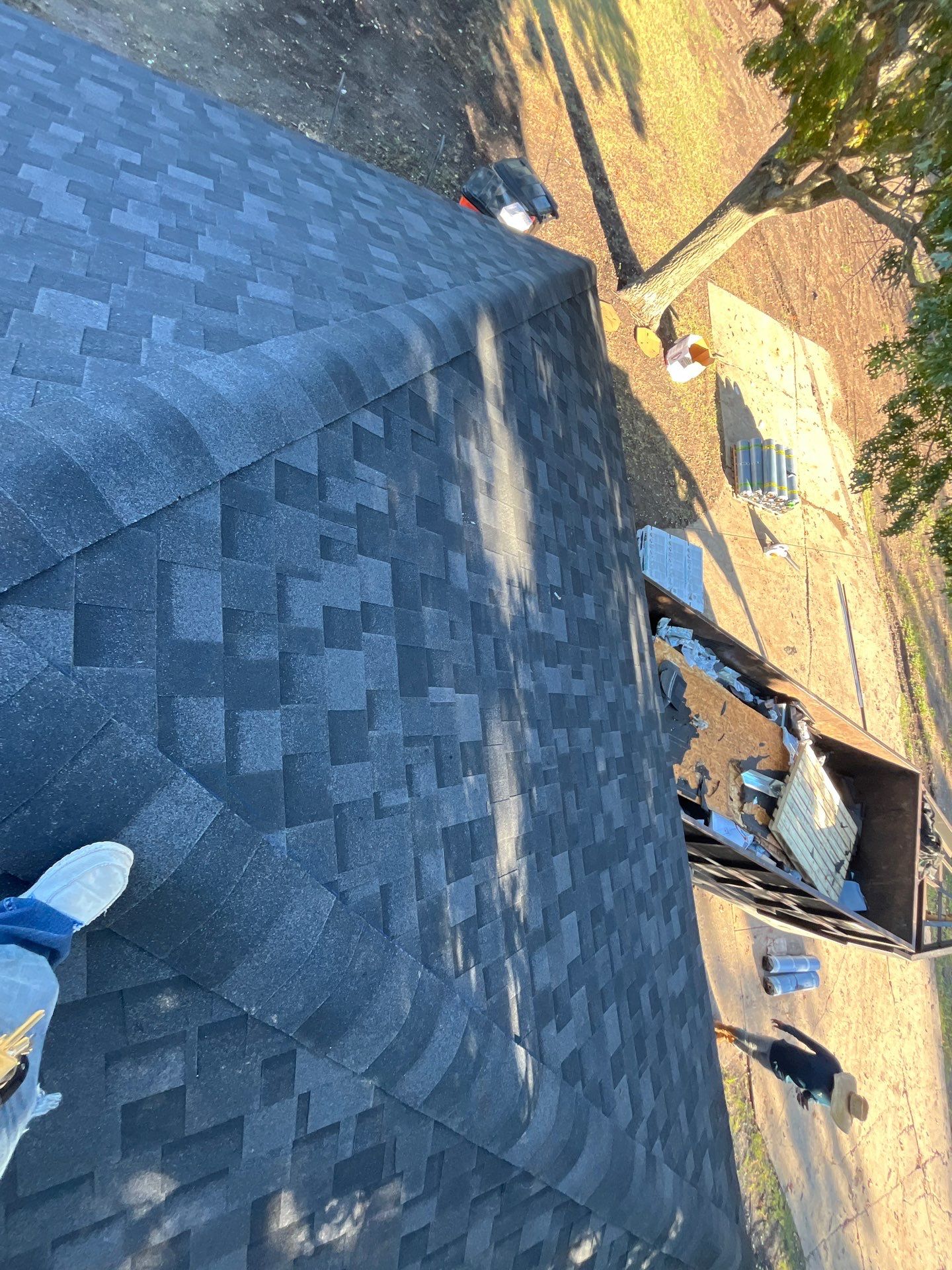 White brick with IKO Granite Black by Tejas Roofworks + Restoration