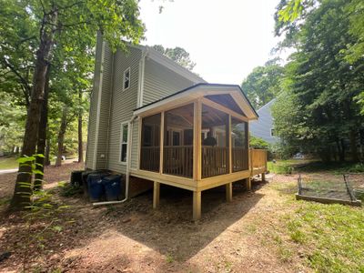 Custom Screen Porch Addition with Gabled Roof and Open Deck