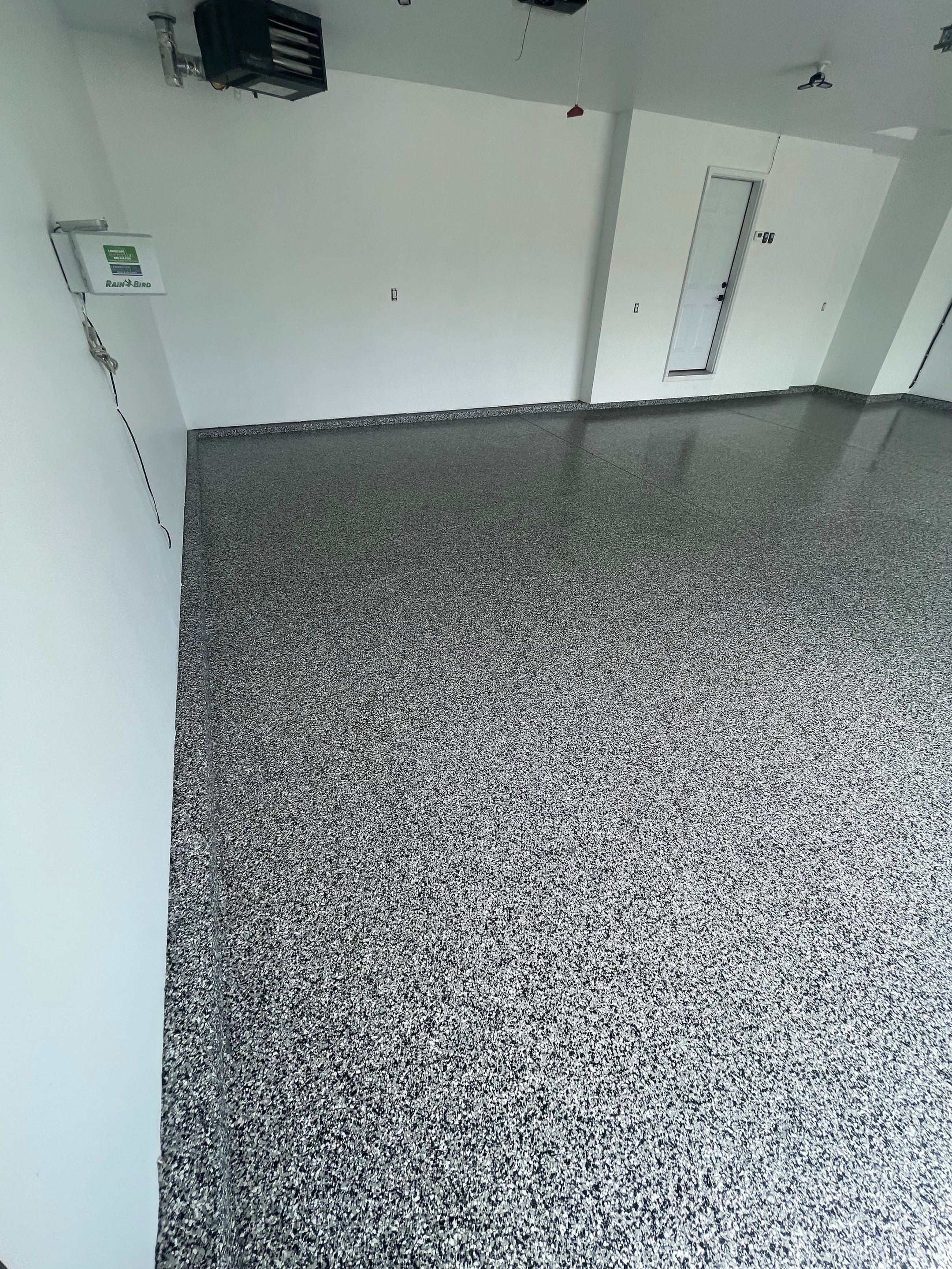 Grey Flake Epoxy Garage Floor Coating in Sioux Falls by Select Painting, Coatings & Garage Cabinets