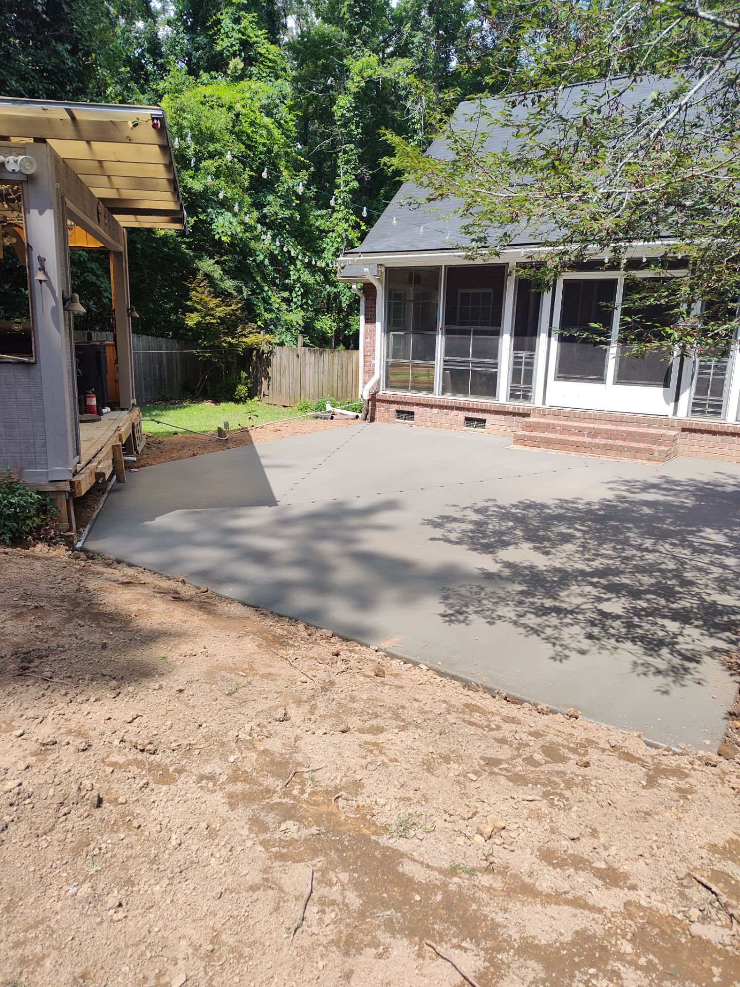 Patio in concrete with drainage improvements by Cornerstone Home Builders, LLC
