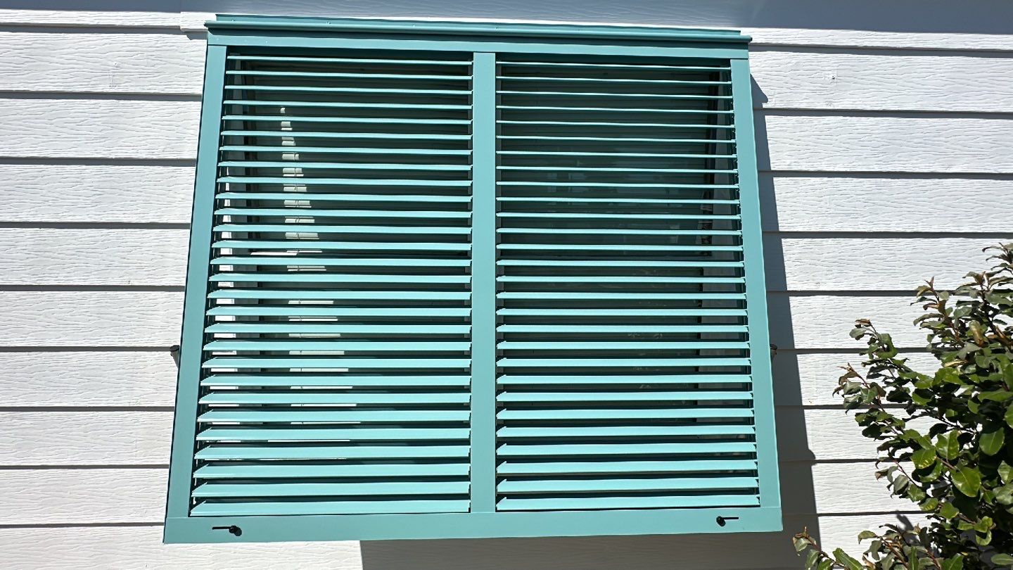 Hurricane Rated Bahama Shutters in Pastel Turquoise by Smart Guard Shutters
