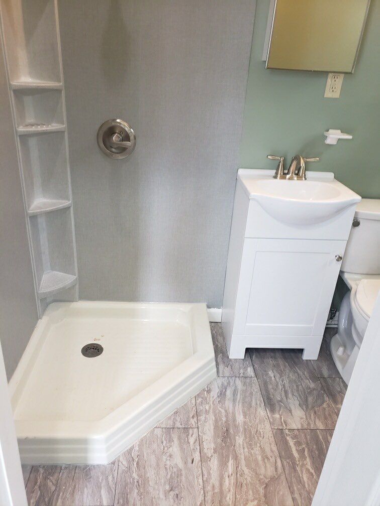 Bathroom Remodel using BCI Acrylic Shower System by Secure Construction Company Inc