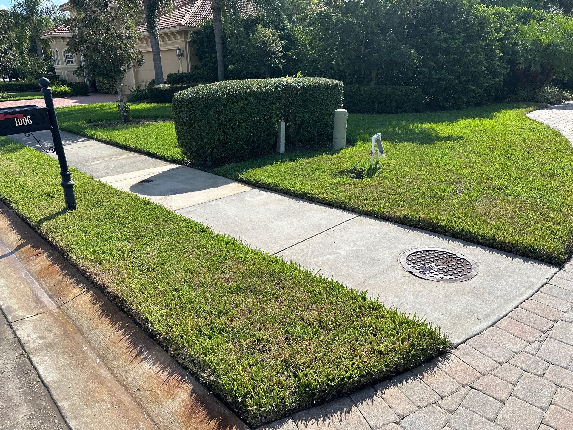 Paver Driveway, Entryway, Sidewalk, and Street Curbing Cleaning in Winding River Community, Bradenton, FL by Sunshine AquaWash