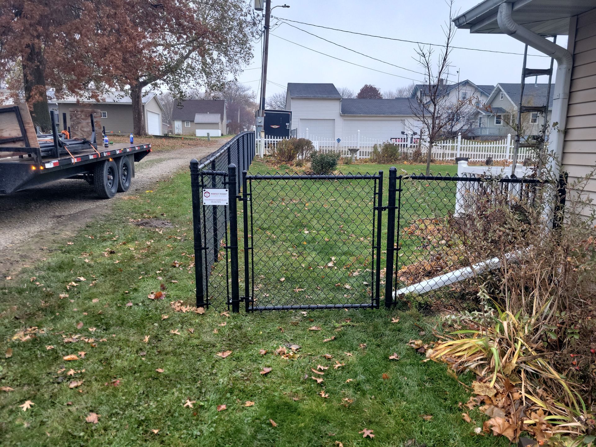 Black Vinyl-Coated Chain Link Fence Installation in Aplington by Perfect Picket Fence and Stain