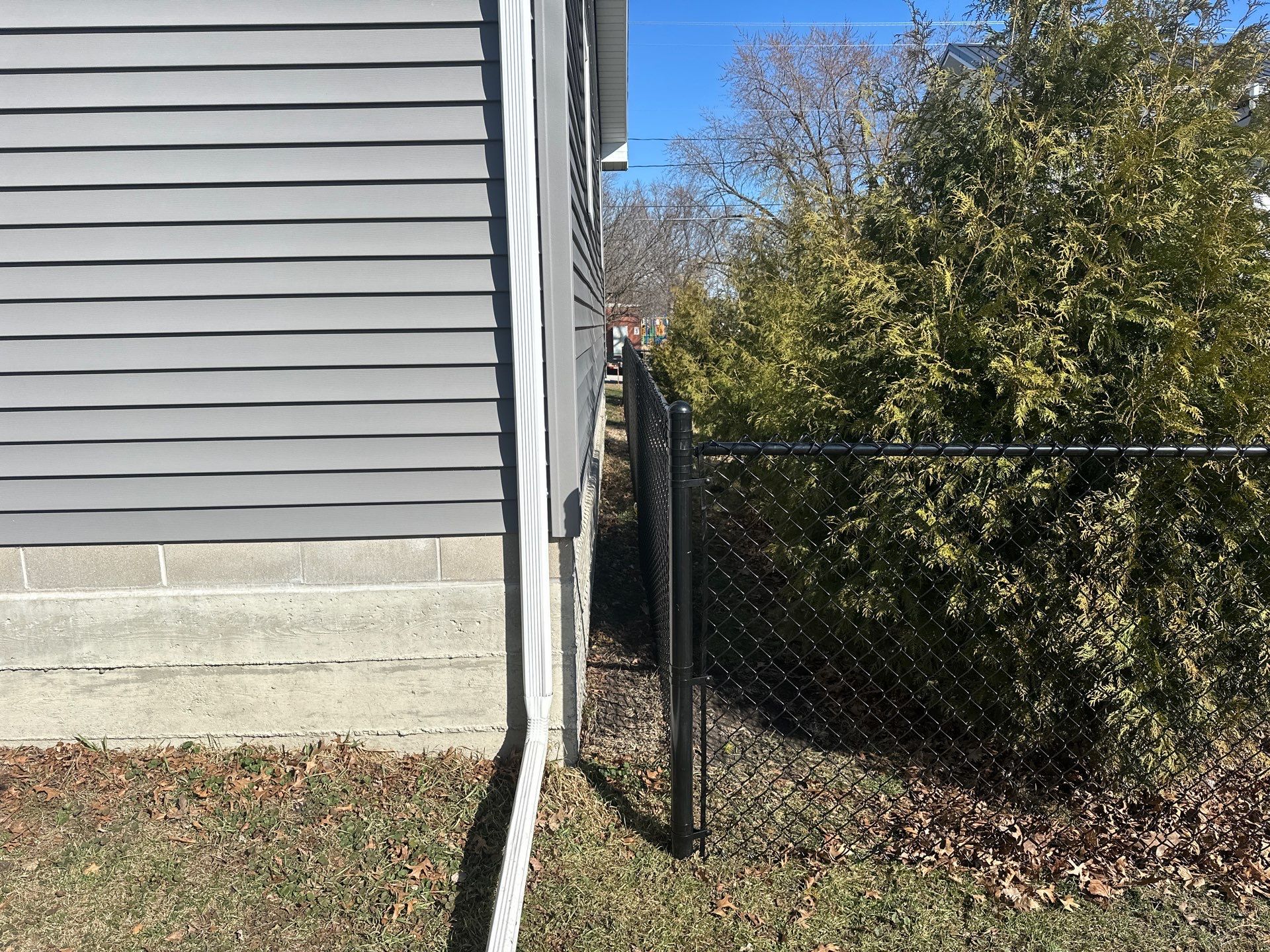 Black Chain Link Backyard Fence Installation in Independence by Perfect Picket Fence and Stain