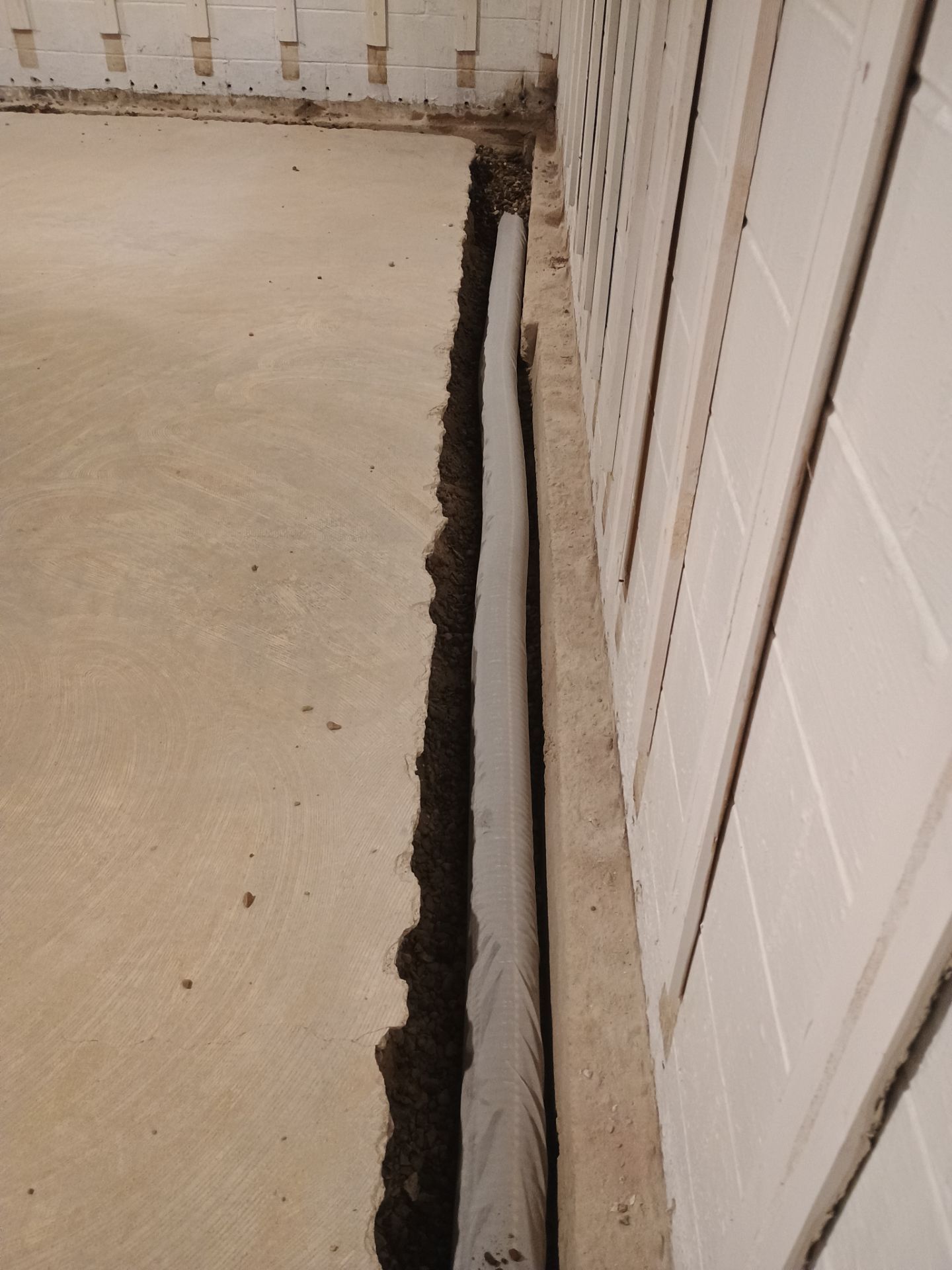 Interior Drain Tile & Buried Discharge in St. Anthony, MN by Waterproofing Northeast