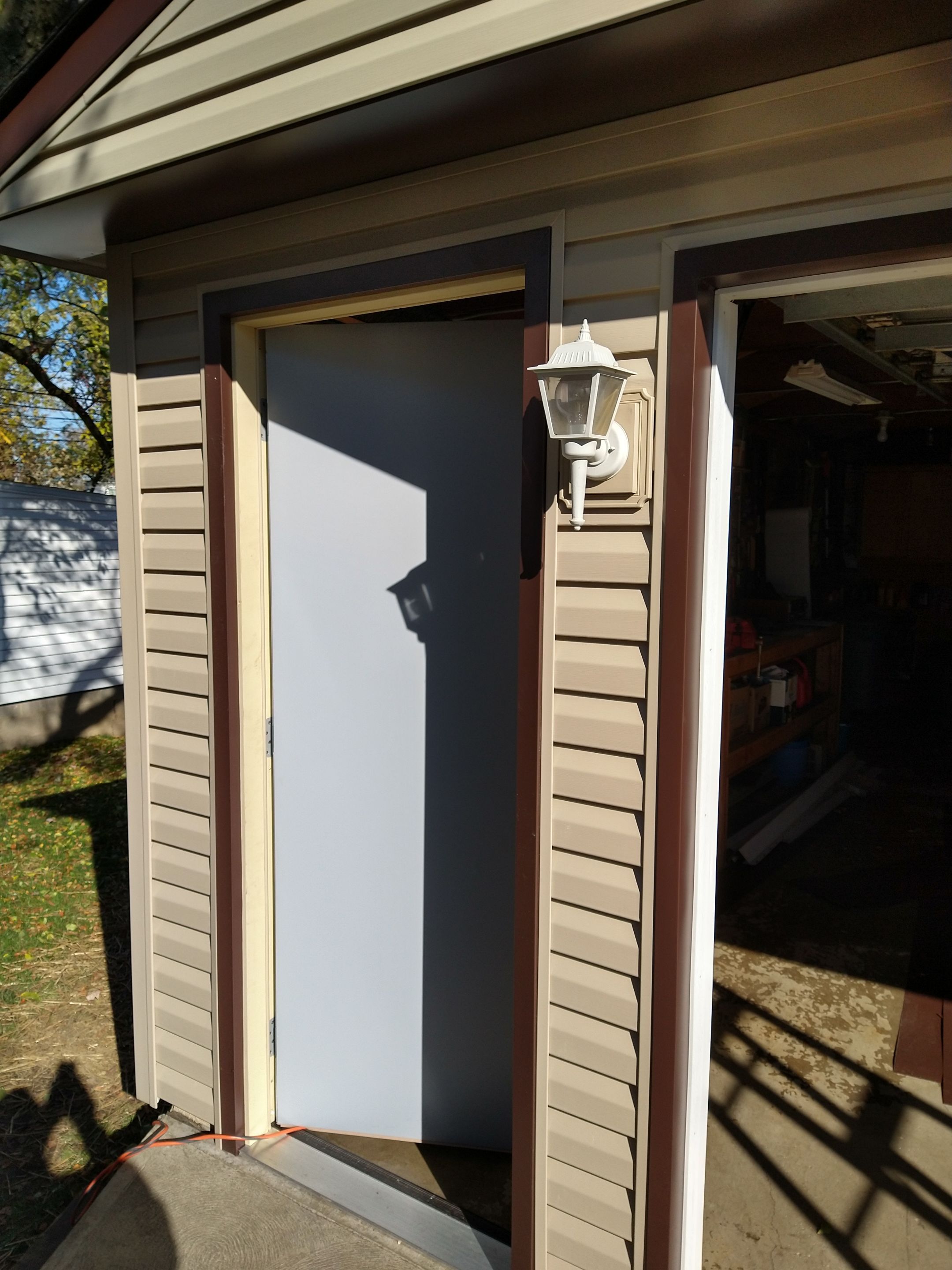 Siding Installation using Norandex woodsman dl-5 white woodgrain vinyl by Absolute Roofing and Construction