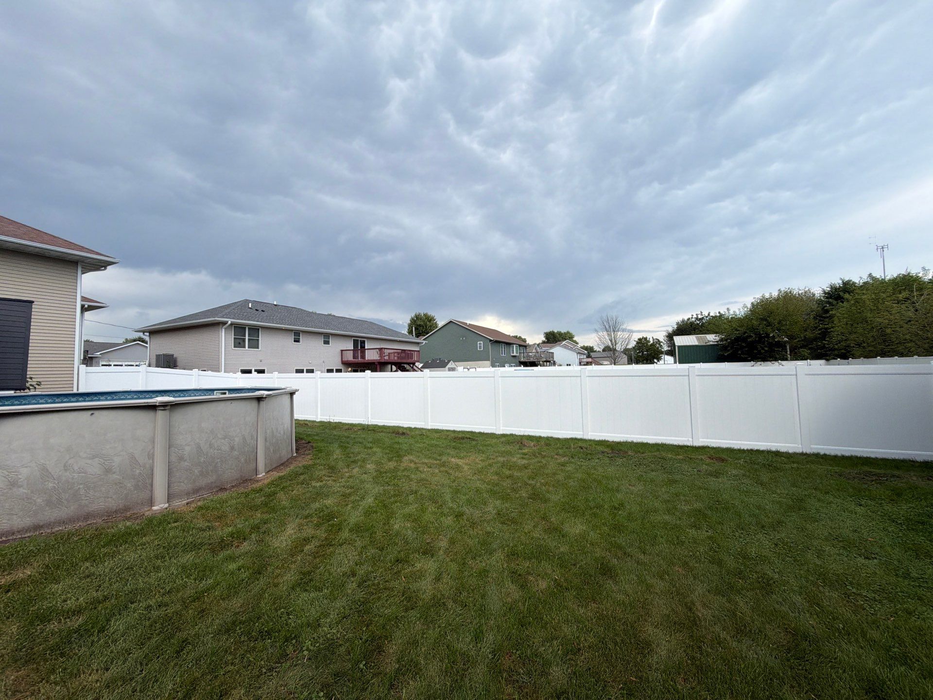 White Vinyl Privacy Fence Installation in Raymond, IA by Perfect Picket Fence and Stain