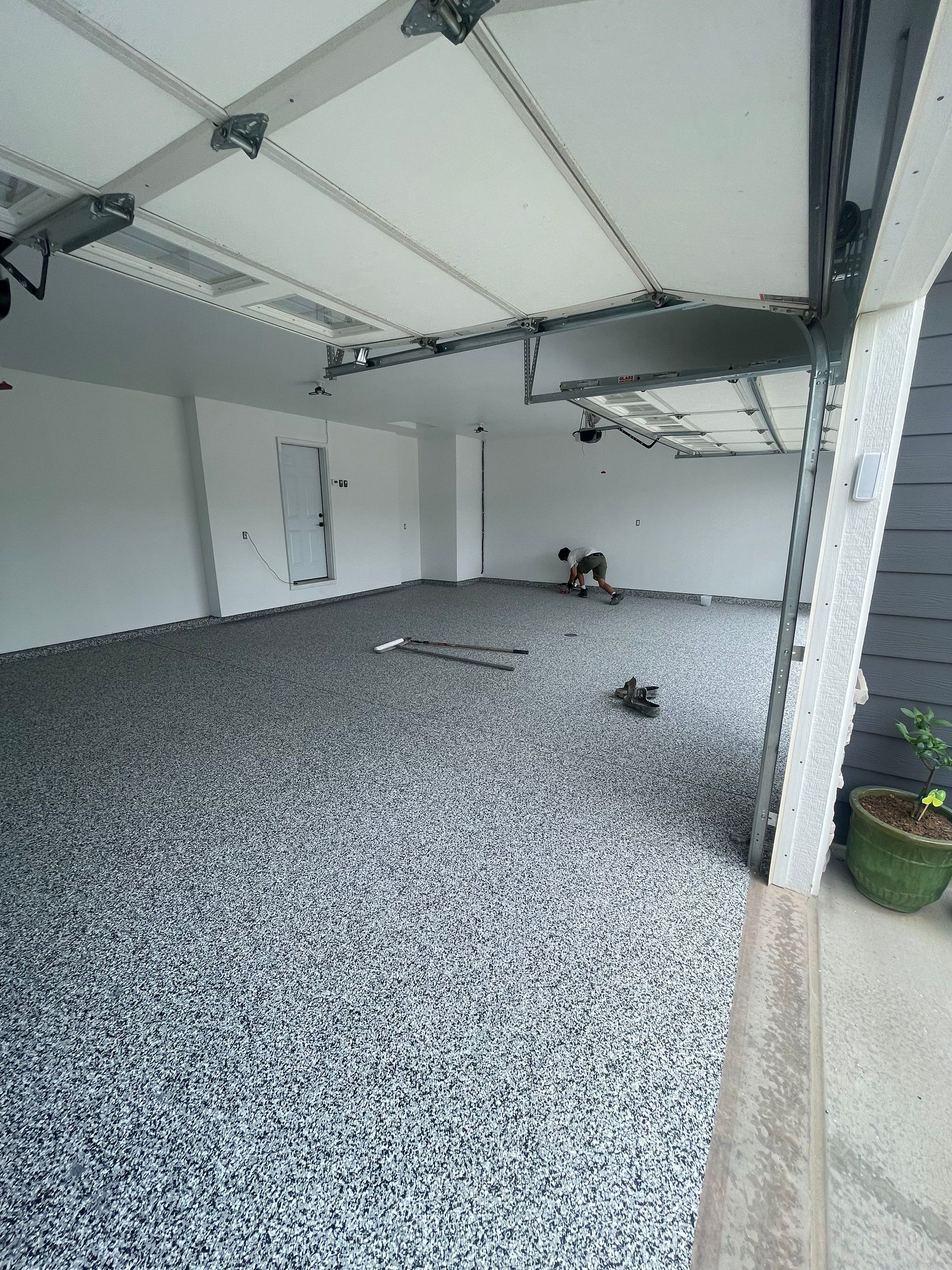 Grey Flake Epoxy Garage Floor Coating in Sioux Falls by Select Painting, Coatings & Garage Cabinets