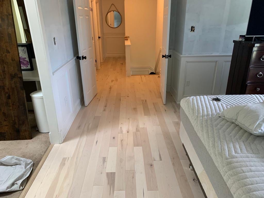 Flooring Installation using Maple Hardwood by Greenspring Construction Services