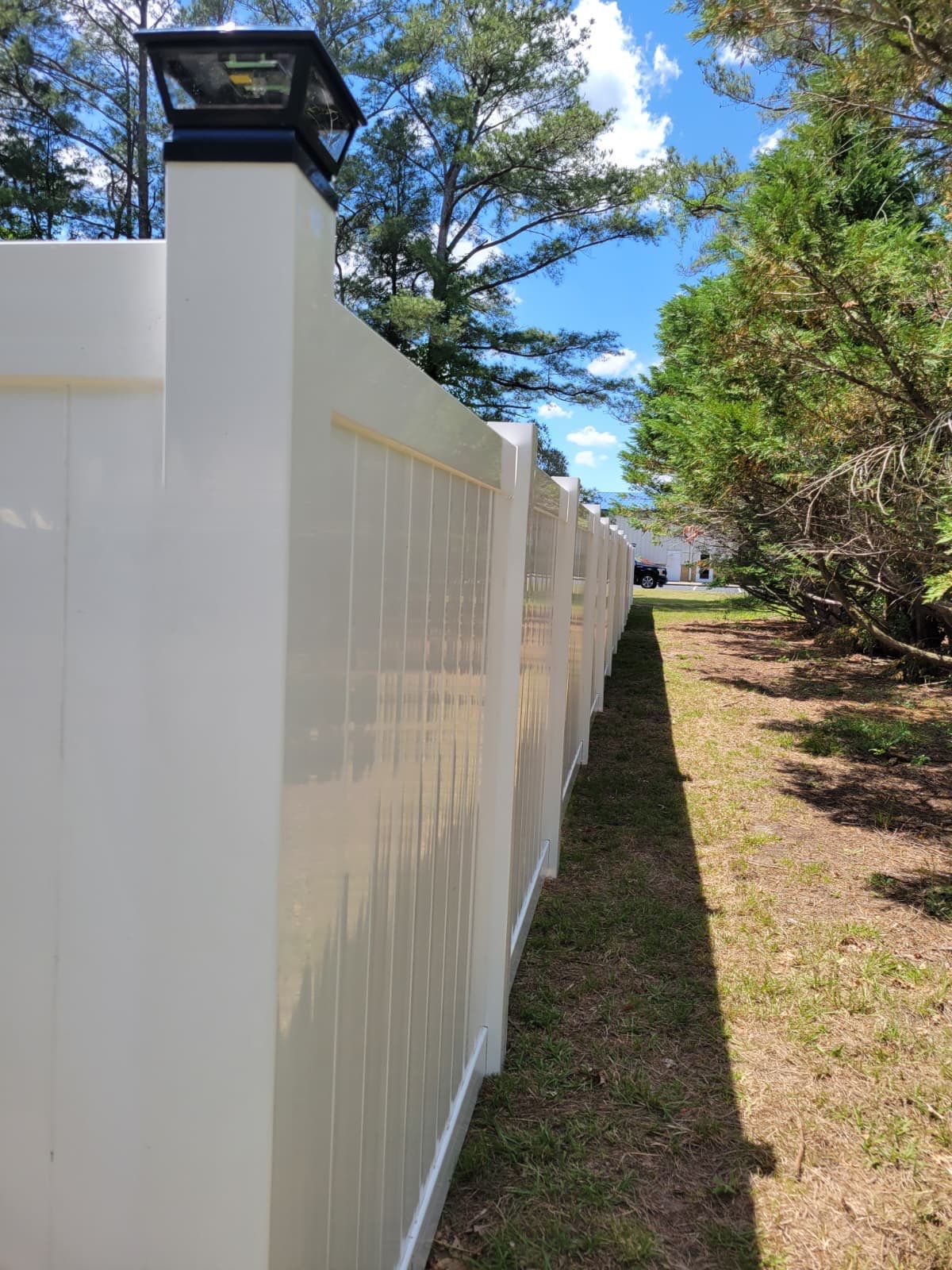 White Vinyl Privacy Fence with Solar Post Caps in Goldsboro by Superior Fence and Rail