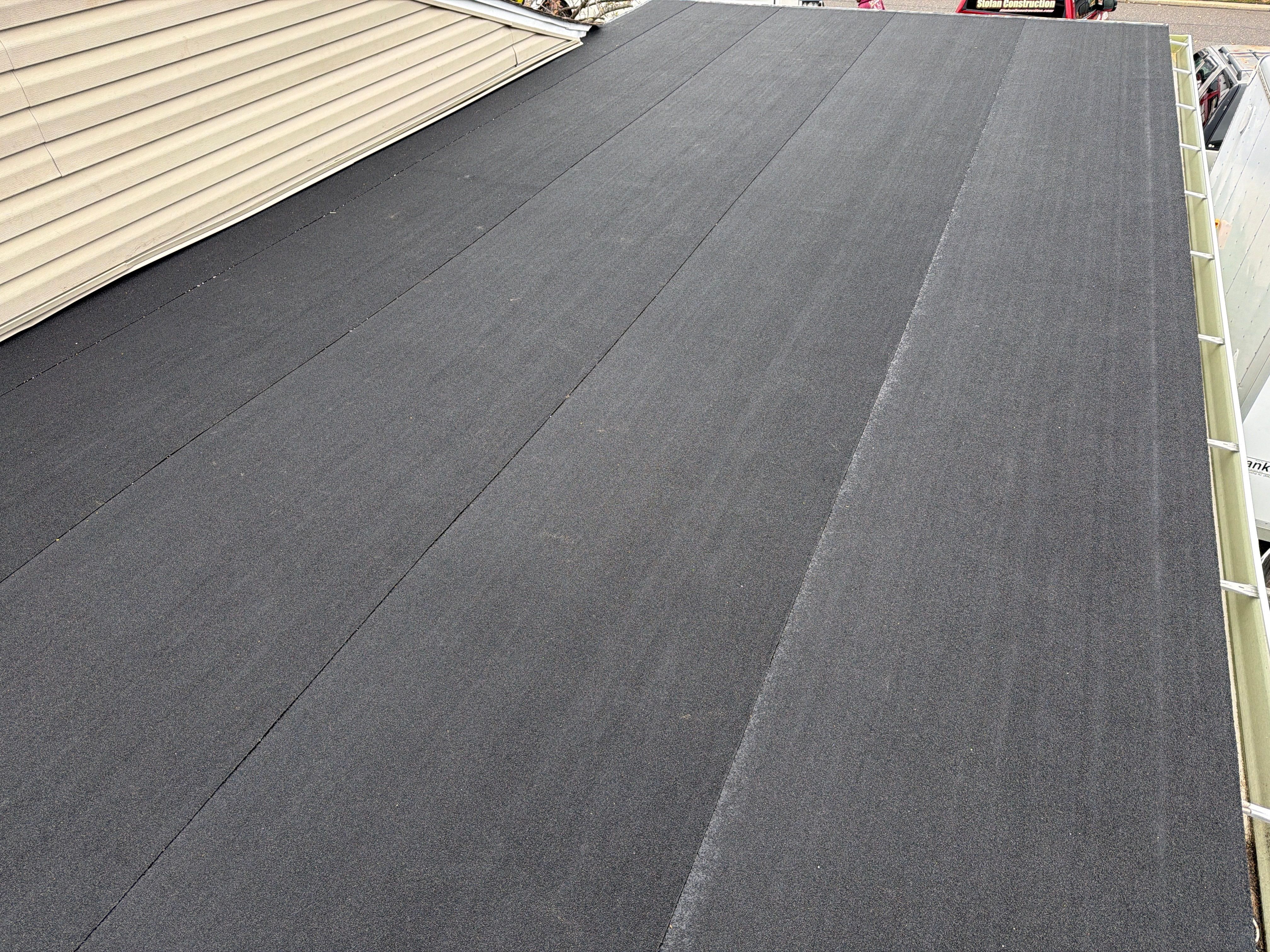 Flat Roof Replacement and Shingle Integration in Levittown by Stofan Construction LLC