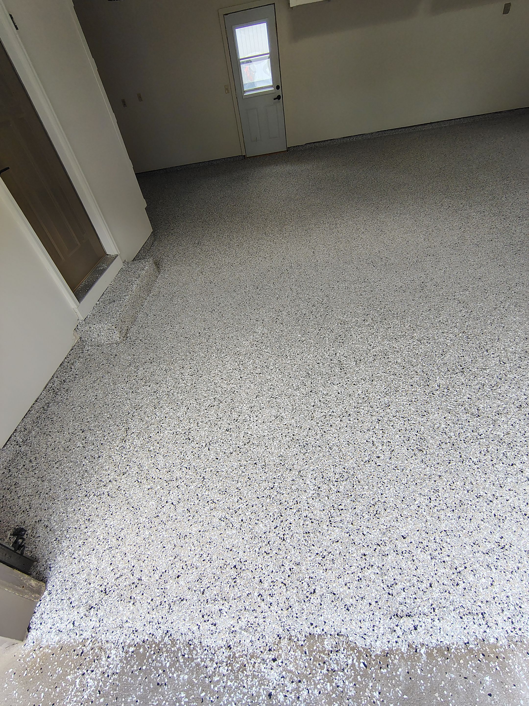 Full-Flake Epoxy Garage Floor Coating Installation in Sioux Falls by Select Painting, Coatings & Garage Cabinets