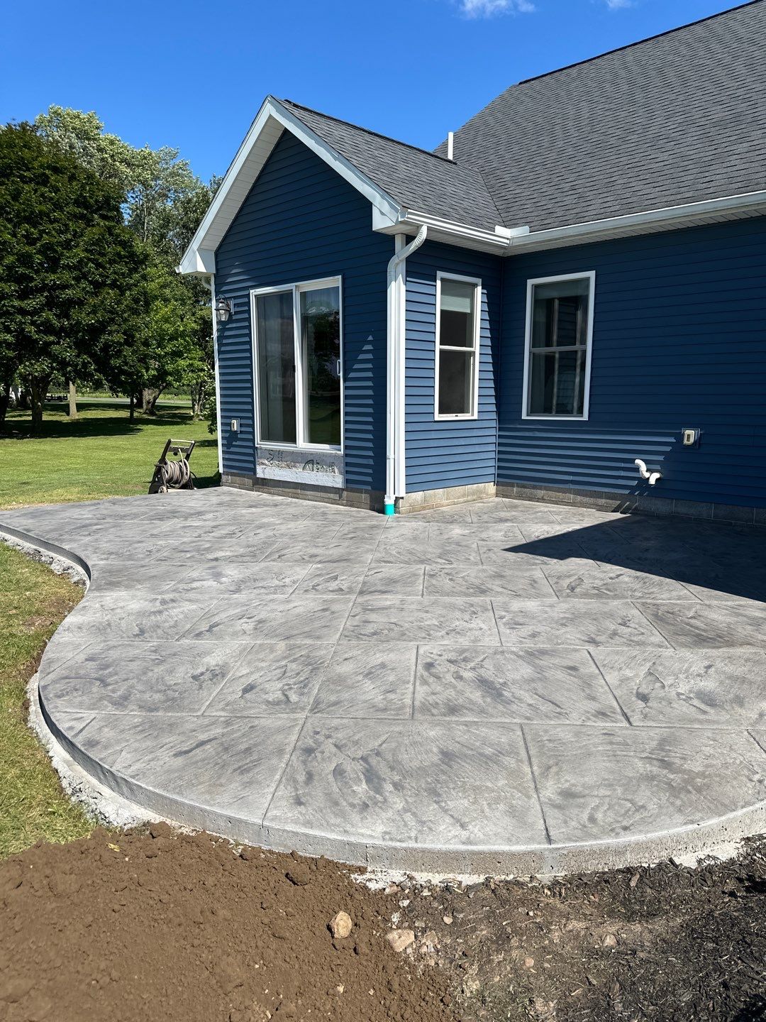 Slate stamped concrete patio  by NG Masonry & Construction LLC