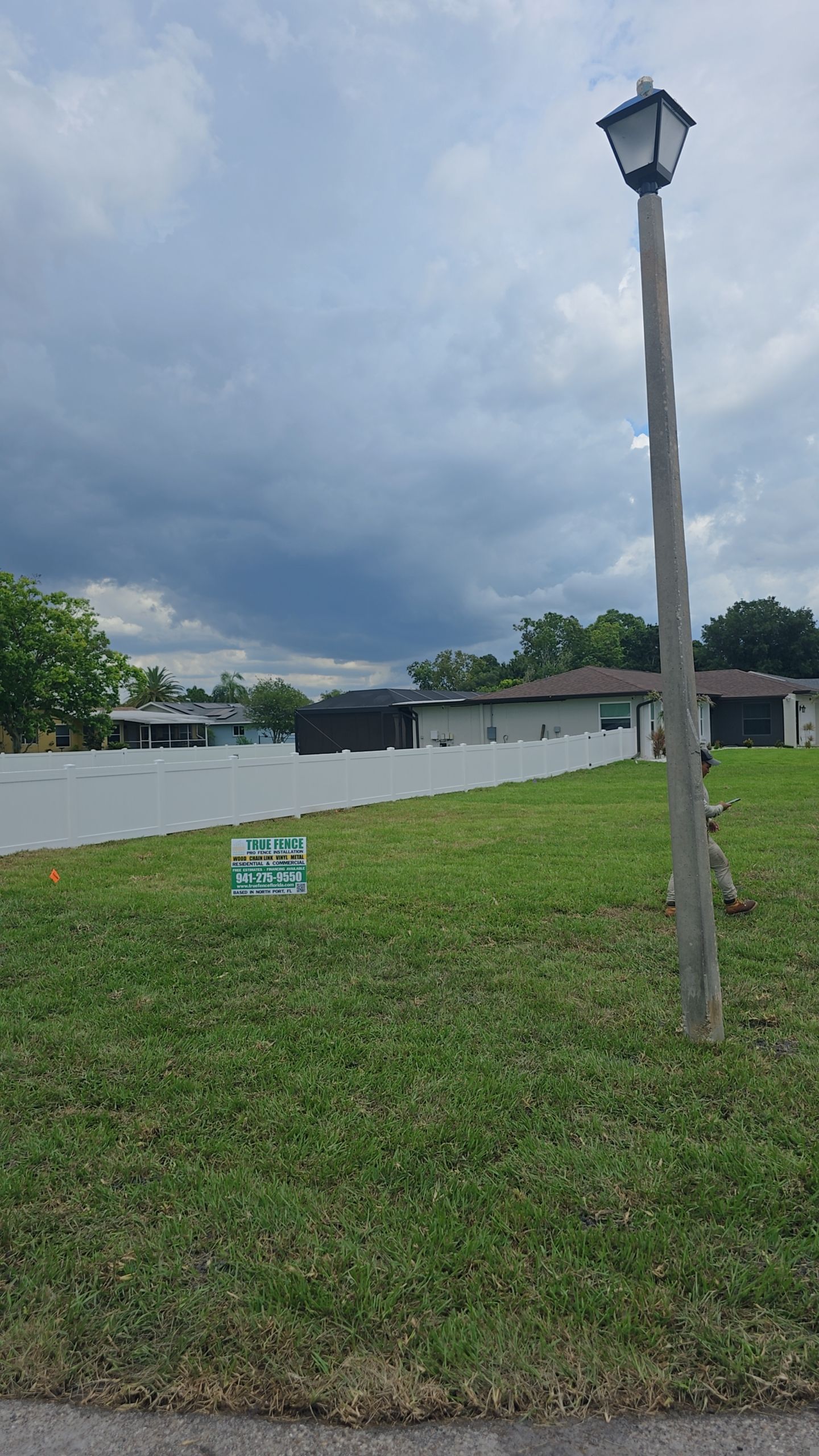 White Vinyl Privacy Fence Installation on Port Charlotte Corner Lot by True Fence LLC