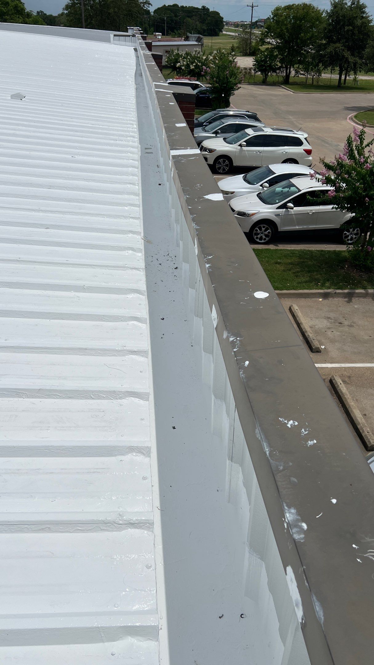 Commercial Roofing Installation using TRP #924 Eterna-Sil Premium Silicone Roof Coating by Harvey Roofing & Construction
