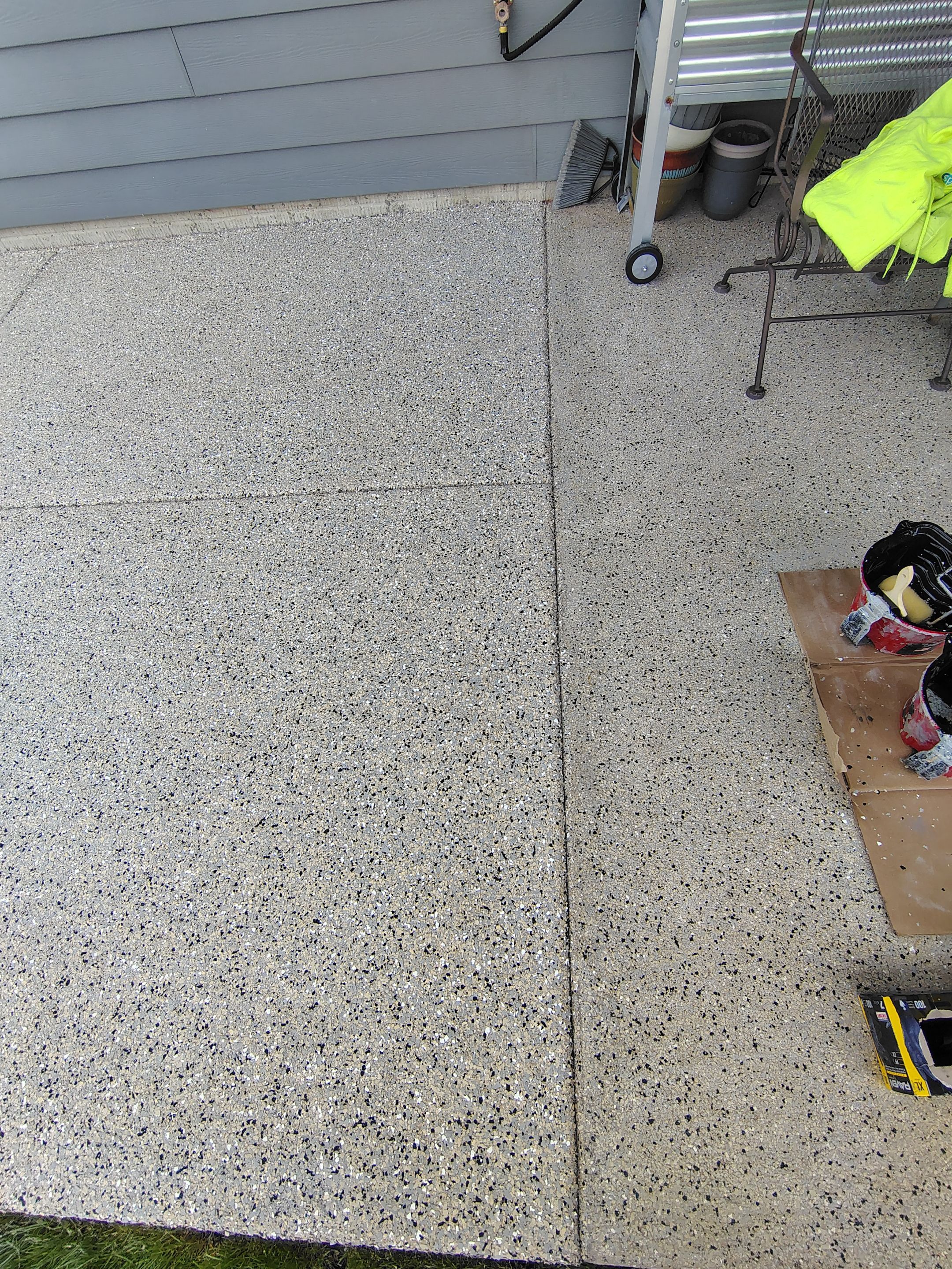 Speckled Concrete Patio Coating Installation in Sioux Falls by Select Painting, Coatings & Garage Cabinets