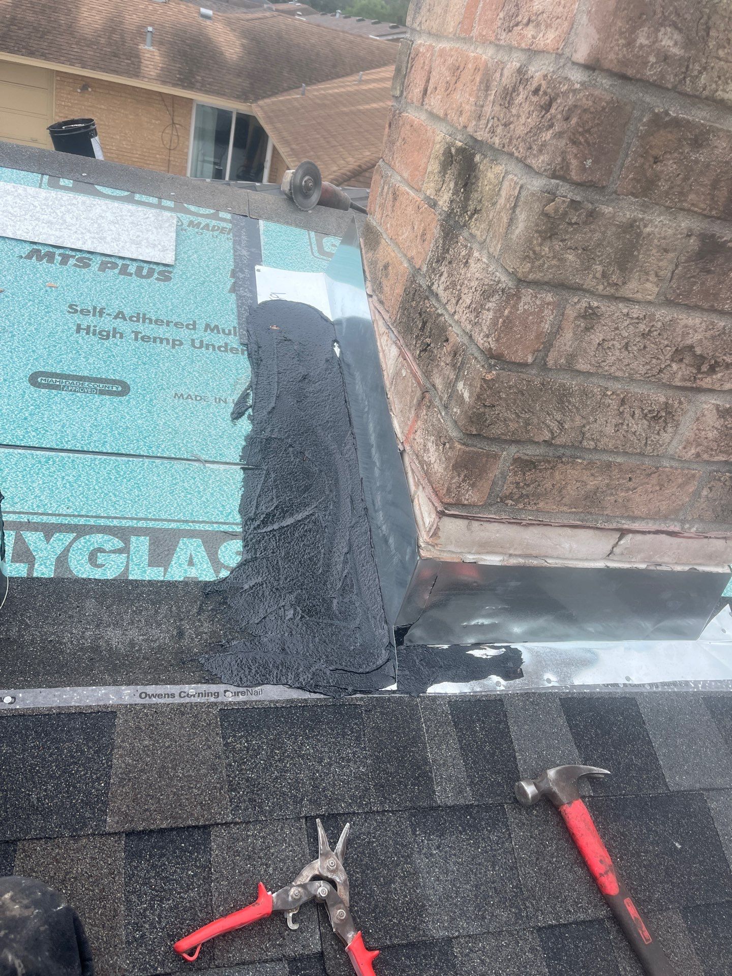 Colored Vinyl Windows to blend into brick by Bayfront Roofing and Construction