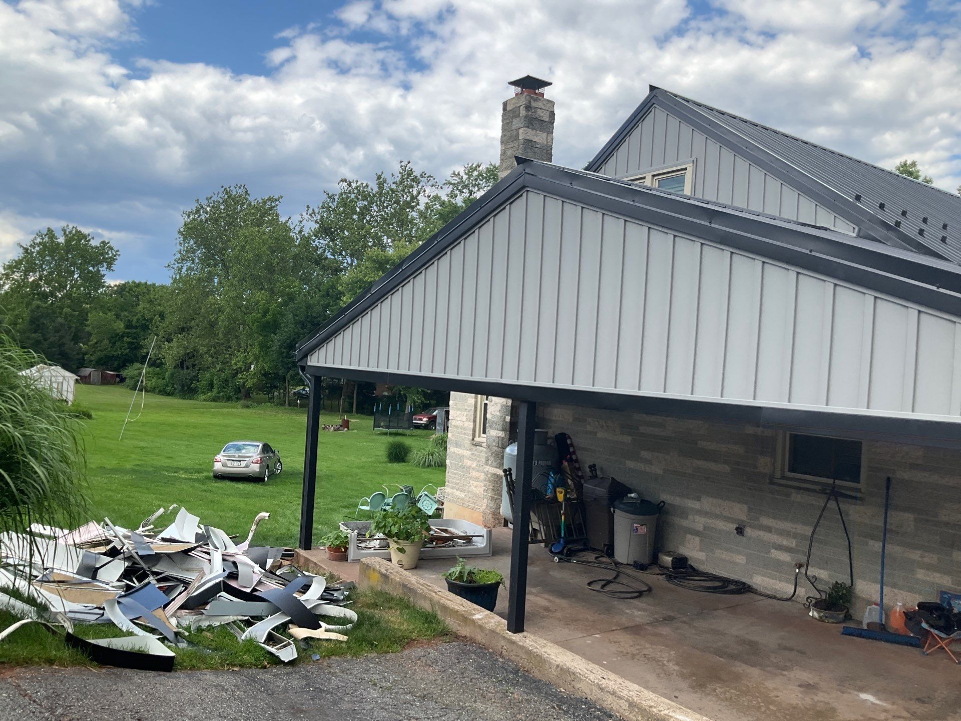 Metal Roofing, Board & Batten Siding, and Entry Door Transformation by Esh Builders