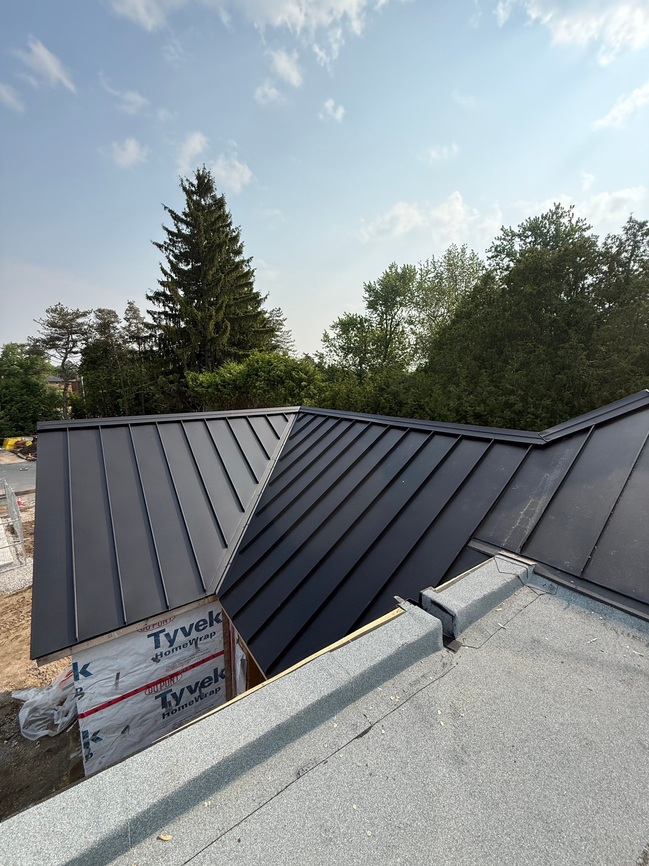 Custom Home Jet Black 24 GA Standing Seam Roof  by Jay Carter Roofing & Sheet Metal