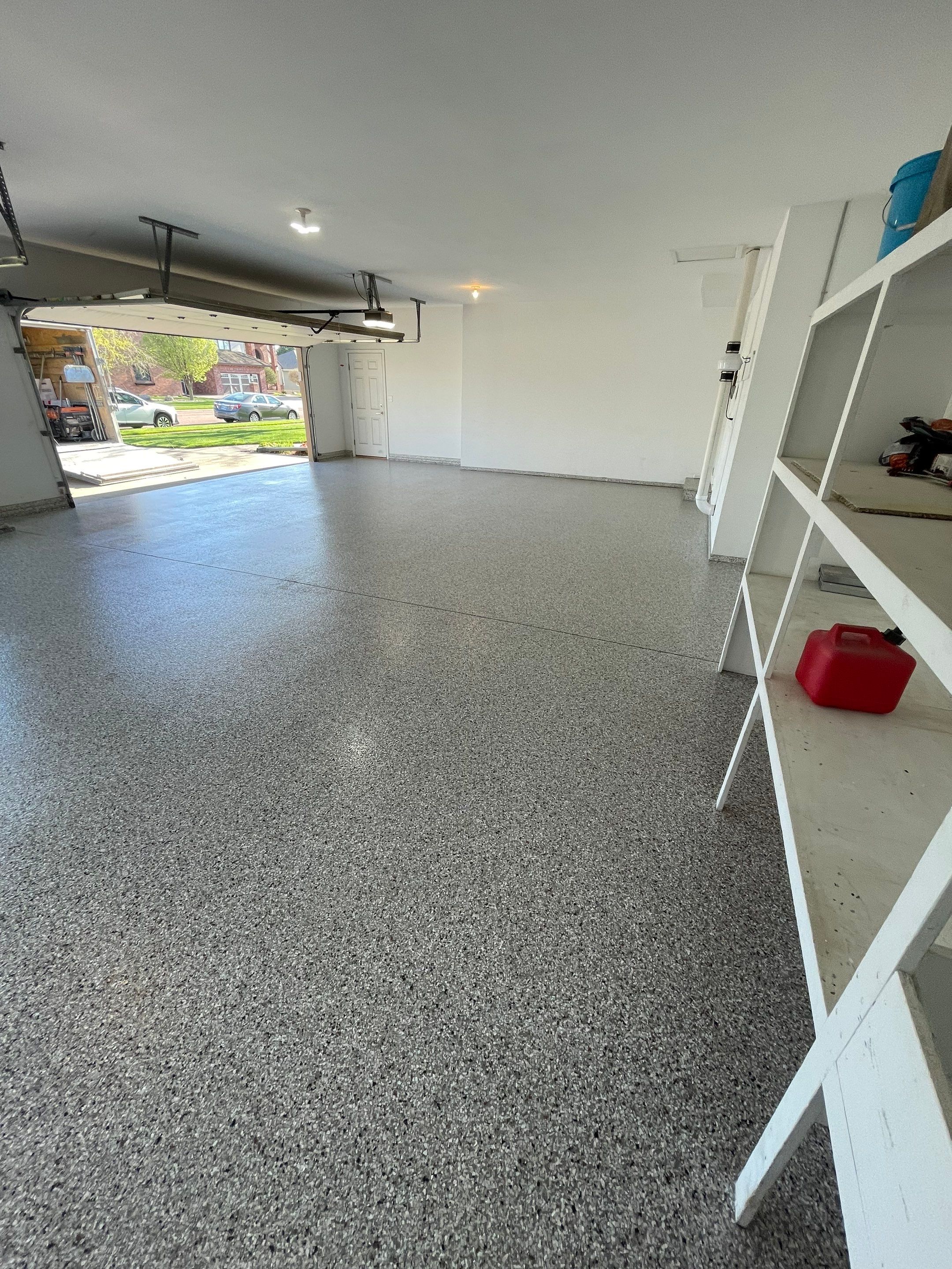 Yankton Garage Floor Restoration with Gray Speckled Epoxy Coating by Select Painting, Coatings & Garage Cabinets