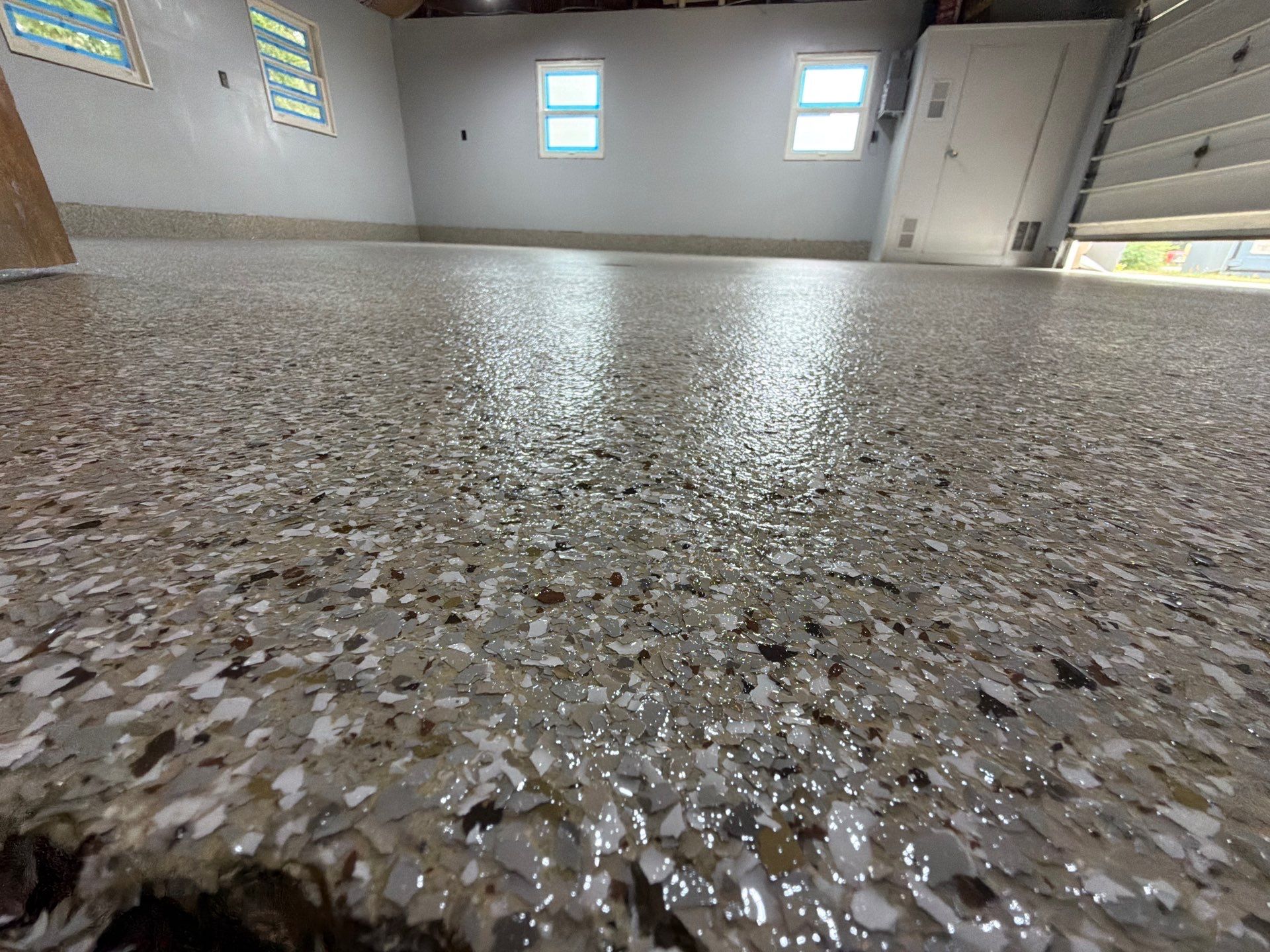 Garage Epoxy Flake Floor Installation and Exterior Siding Repairs in Muskegon by Gordon Painting
