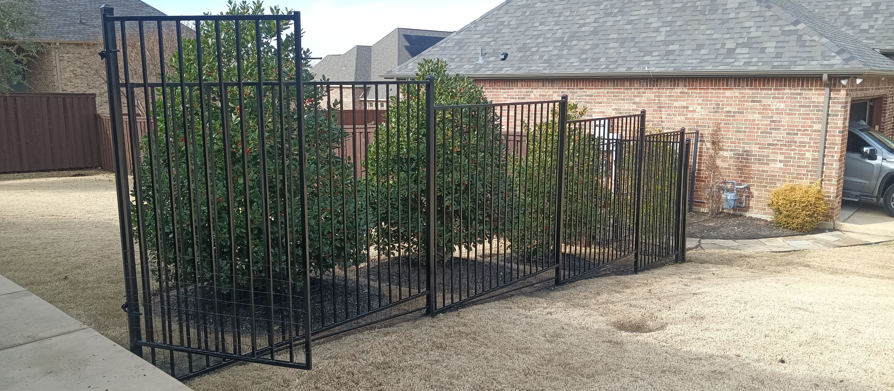 Wrought iron painting using DTM gloss black enamel by Grizzly Fence And Patio