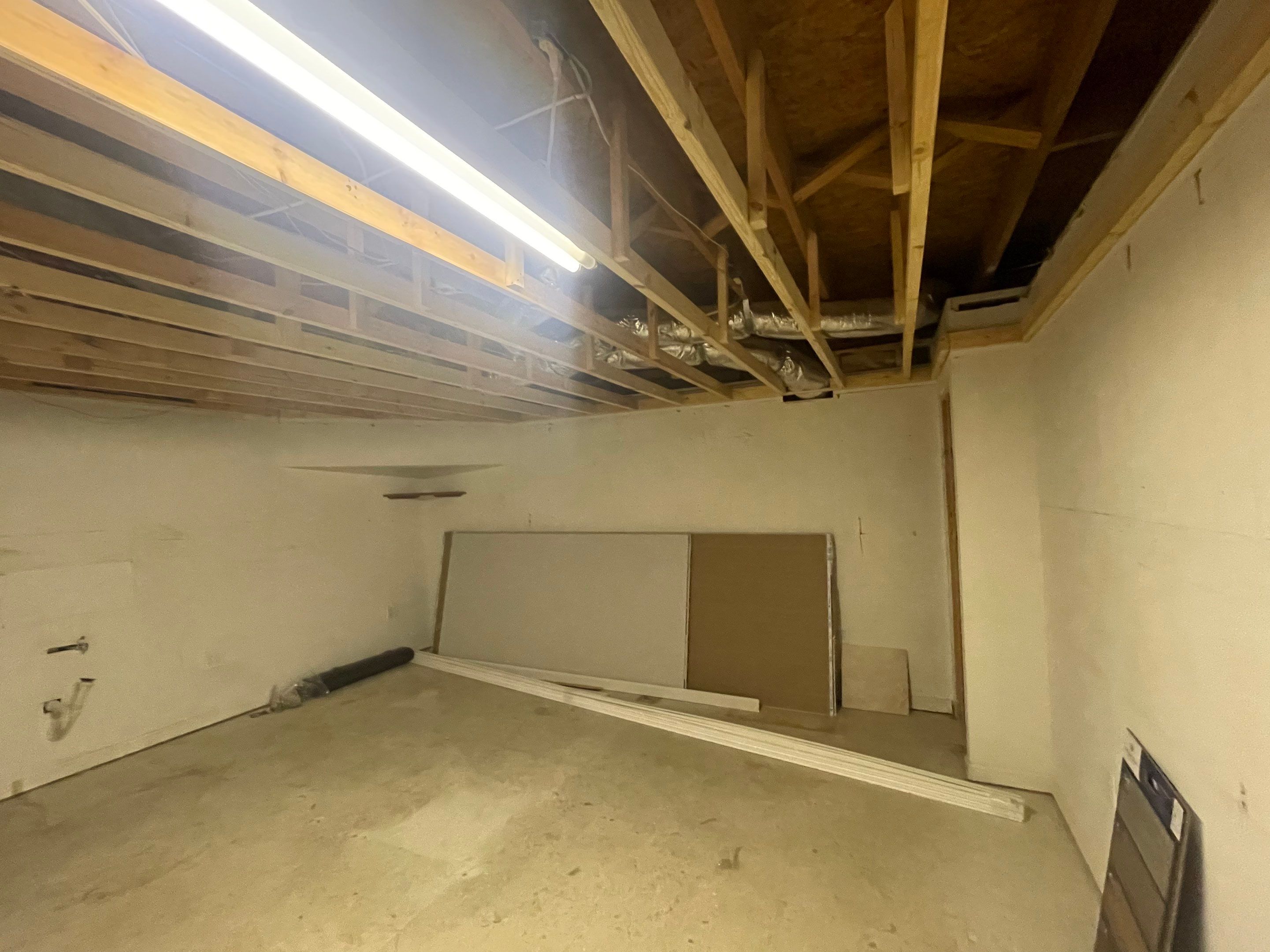 Finished Basement Room Transformation with Wood-Look Flooring in Roswell by Swift Home Renovations