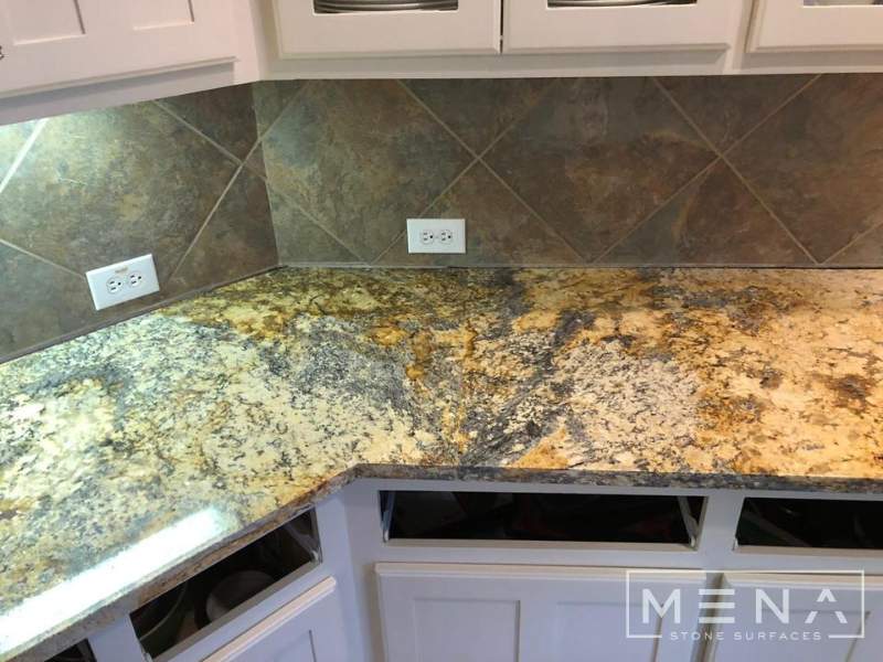 Kitchen countertops using Yellow River Granite  by Mena stone surfaces