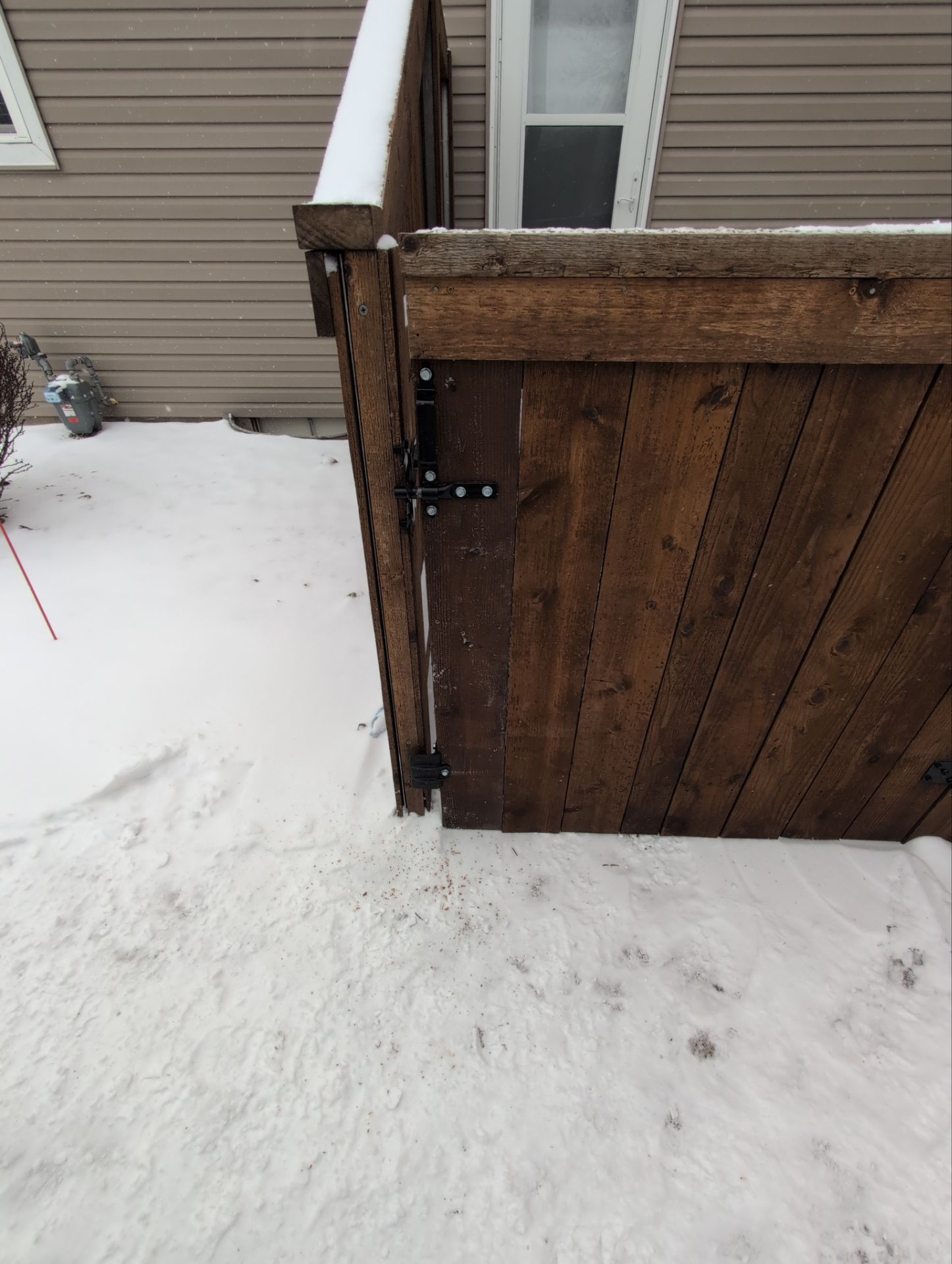 Dark Stained Cedar Privacy Fence and Custom Gates in Cedar Falls by Perfect Picket Fence and Stain