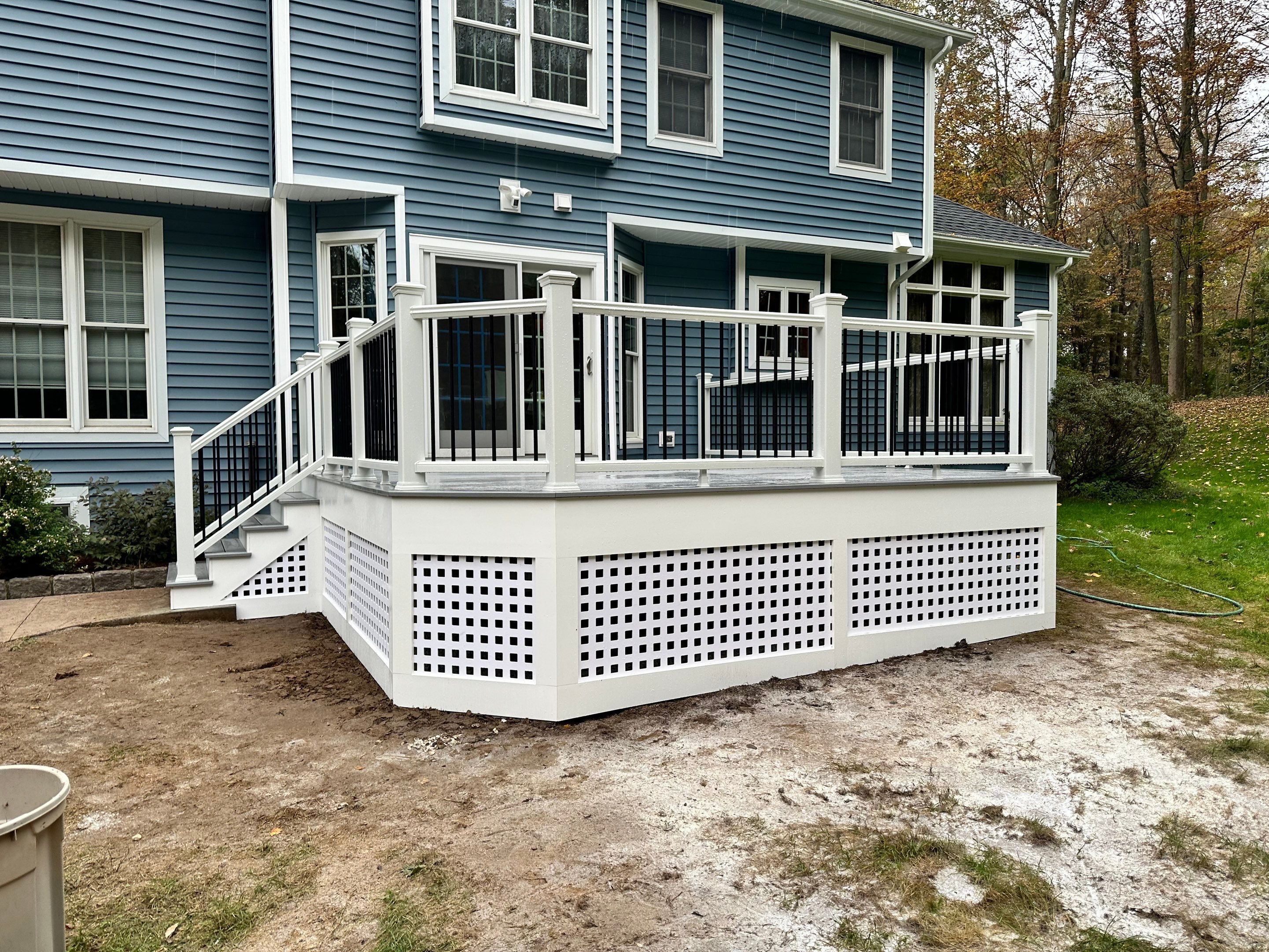 Deck replacement using Trex lineage Rainier with angled edges, Transcend cocktail rail and lattice. by DiGiorgi Roofing and Siding Inc
