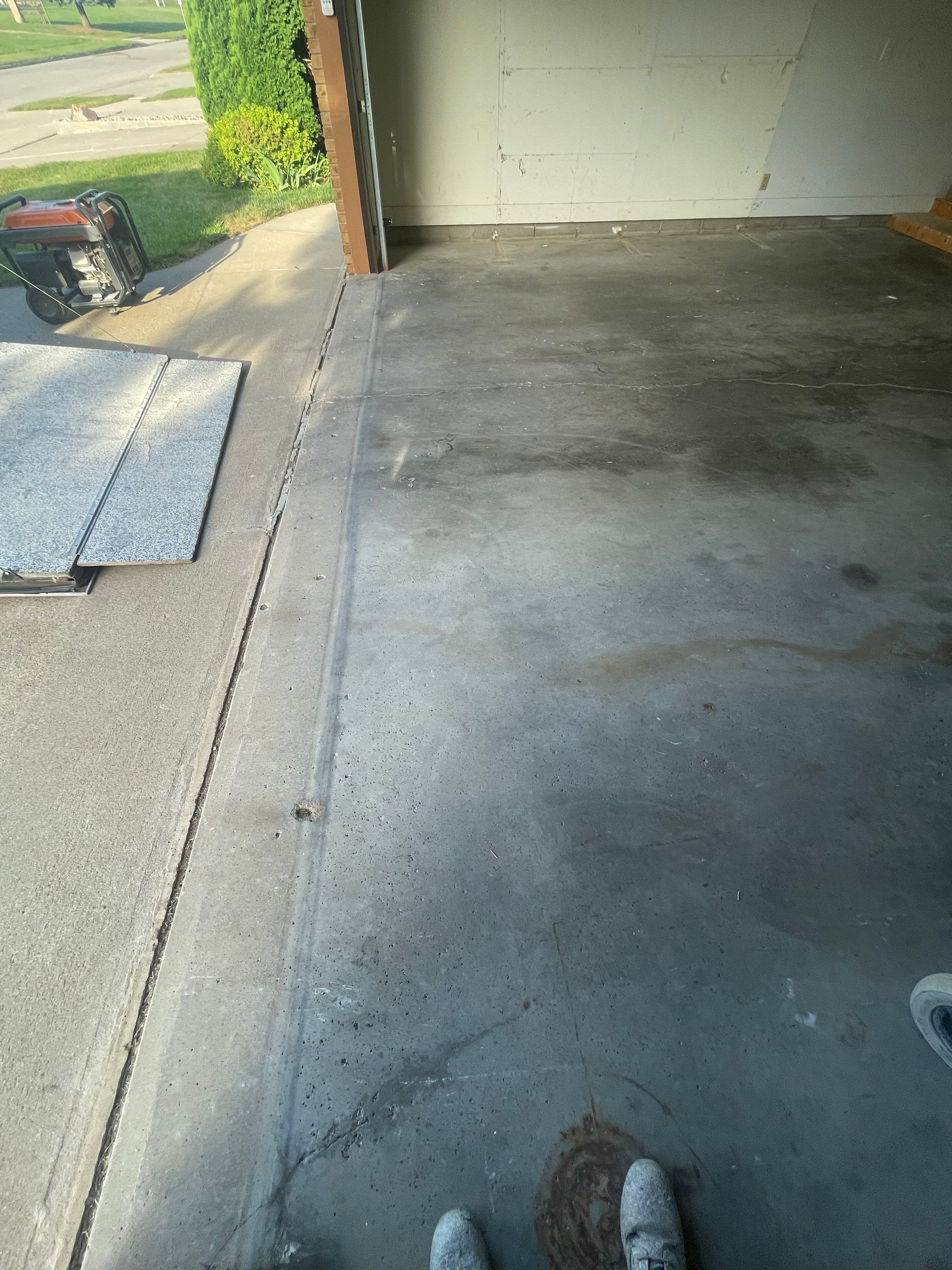 Grey Speckled Concrete Coating for Residential Garage in Yankton by Select Painting, Coatings & Garage Cabinets