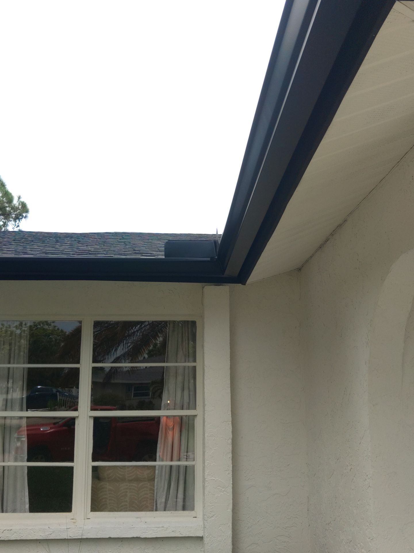 Black seamless gutters and downspouts installation in Sarasota, FL by Gutter Professors