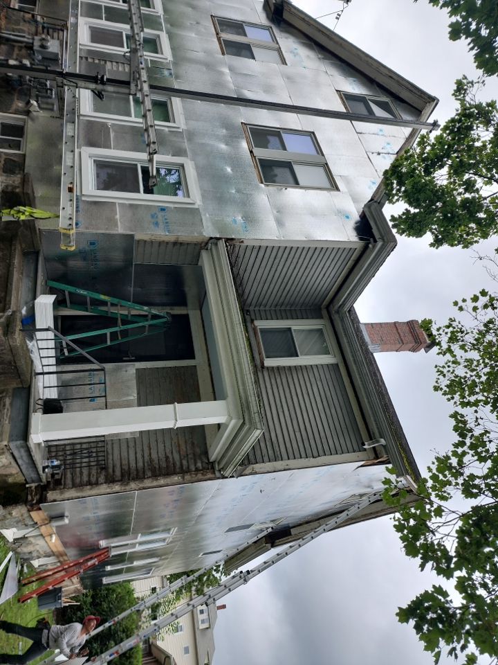 Vinyl siding layover project for 2 family in Wellesley, MA by UBrothers Construction