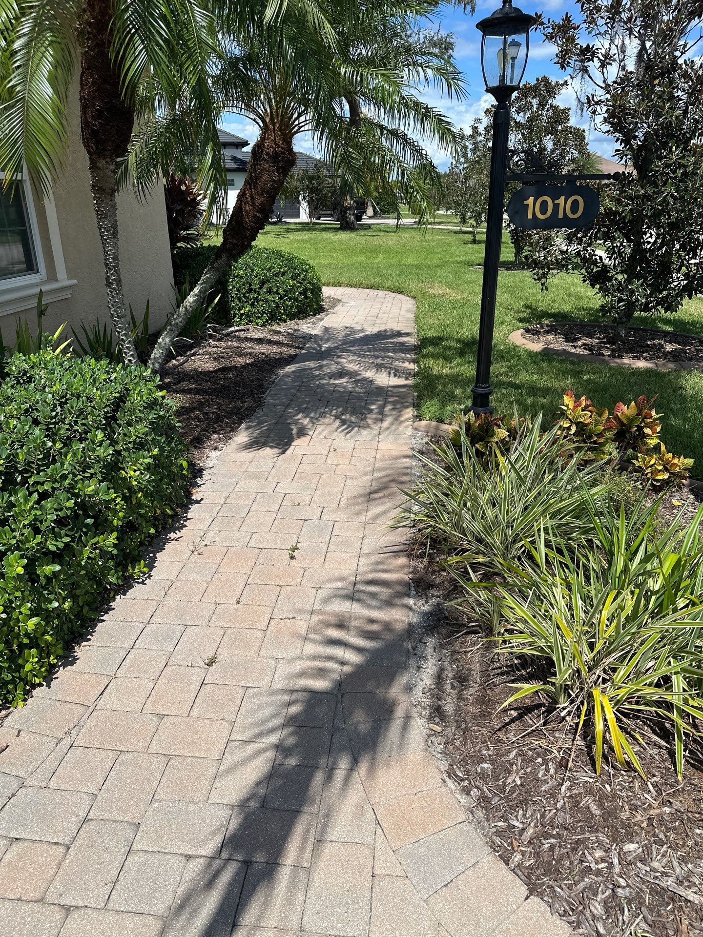 Paver Driveway, Entryway, Sidewalk, and Street Curbing Cleaning in Winding River Community, Bradenton, FL by Sunshine AquaWash