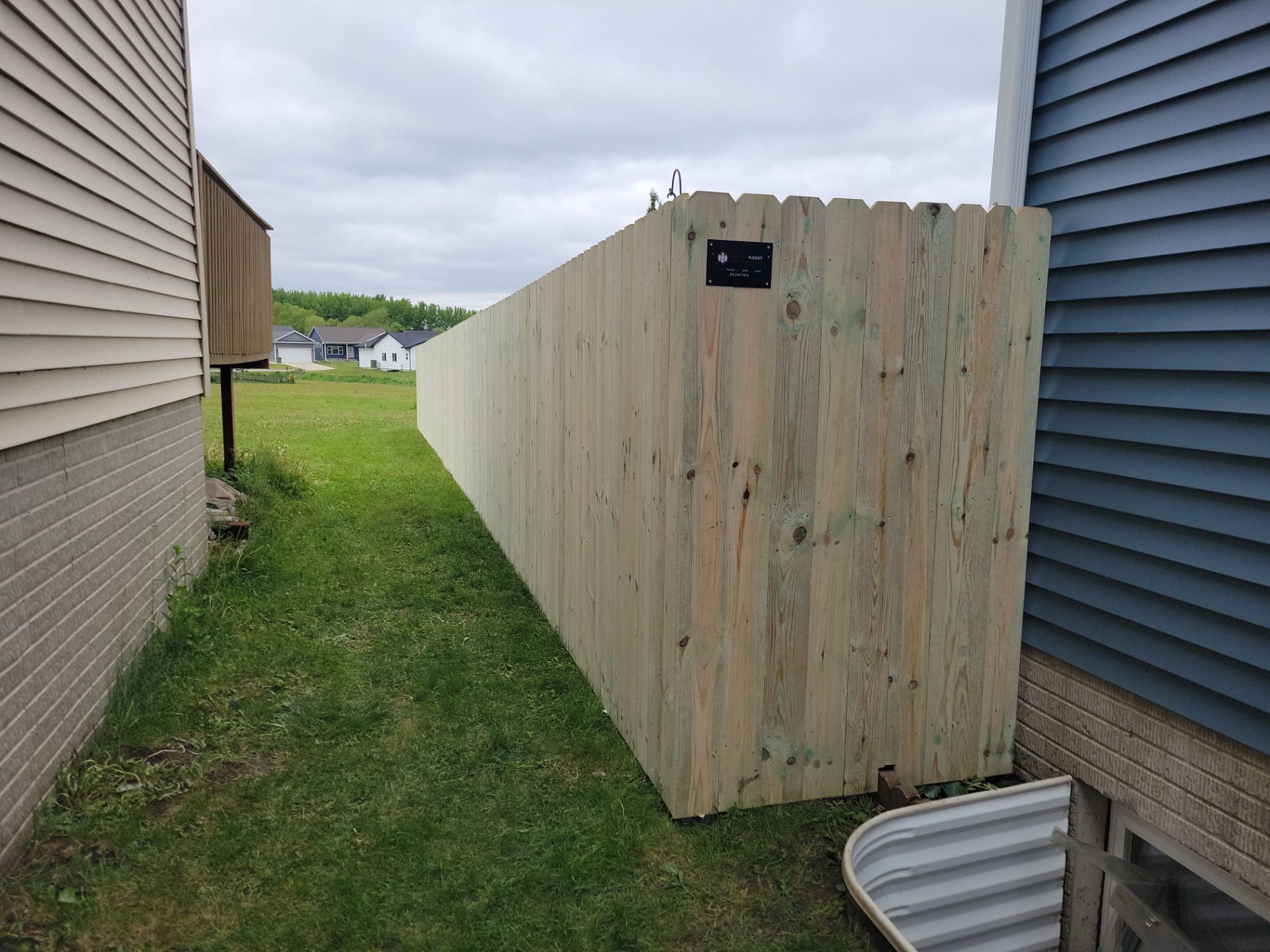Pressure-Treated Wood Privacy Fence Installation in Waterloo by Perfect Picket Fence and Stain