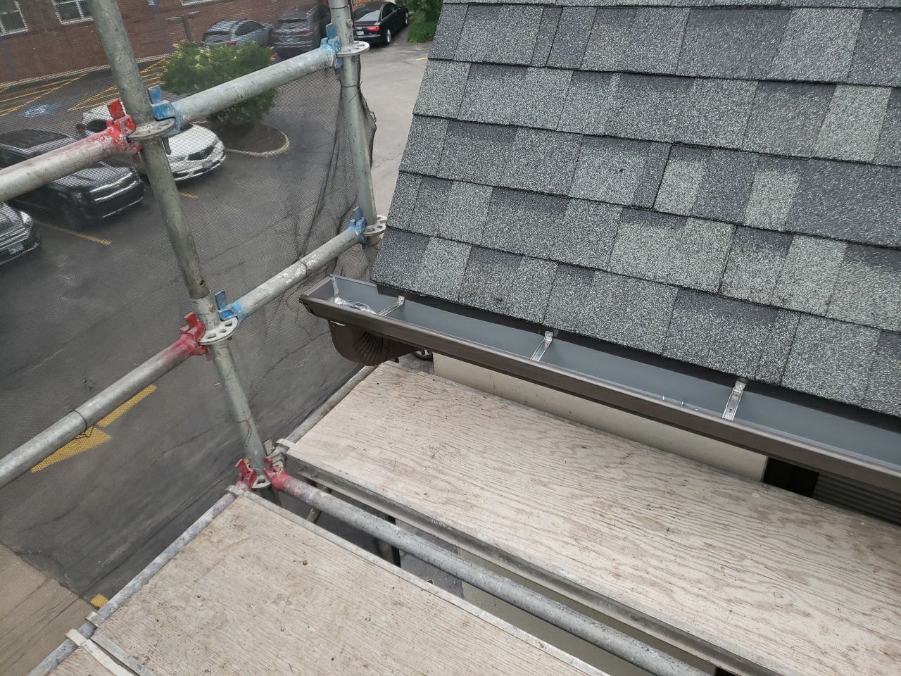 Asphalt Roof Replacement with Aluminum Gutter Installation by Custom Installations