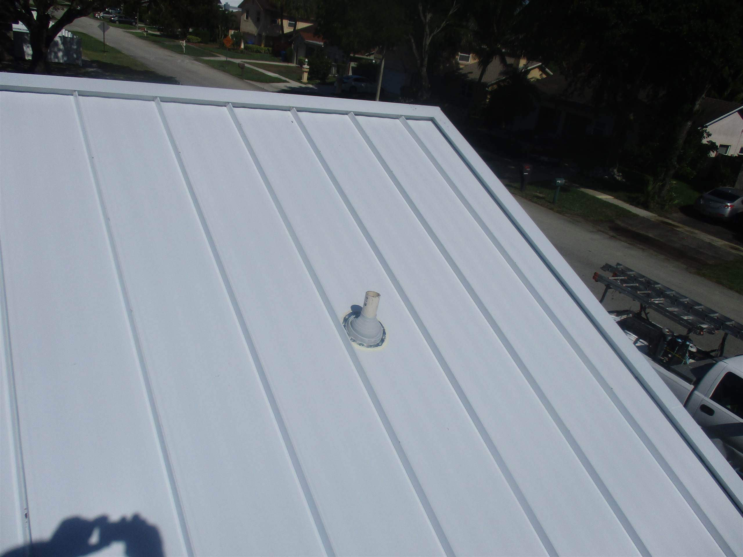Standing Seam Metal & Flat Re-Roof using 1.5" Nail Strip 24ga Solar White Kynar Coated Standing Seam Metal Panels by Morton Roofing, Inc.