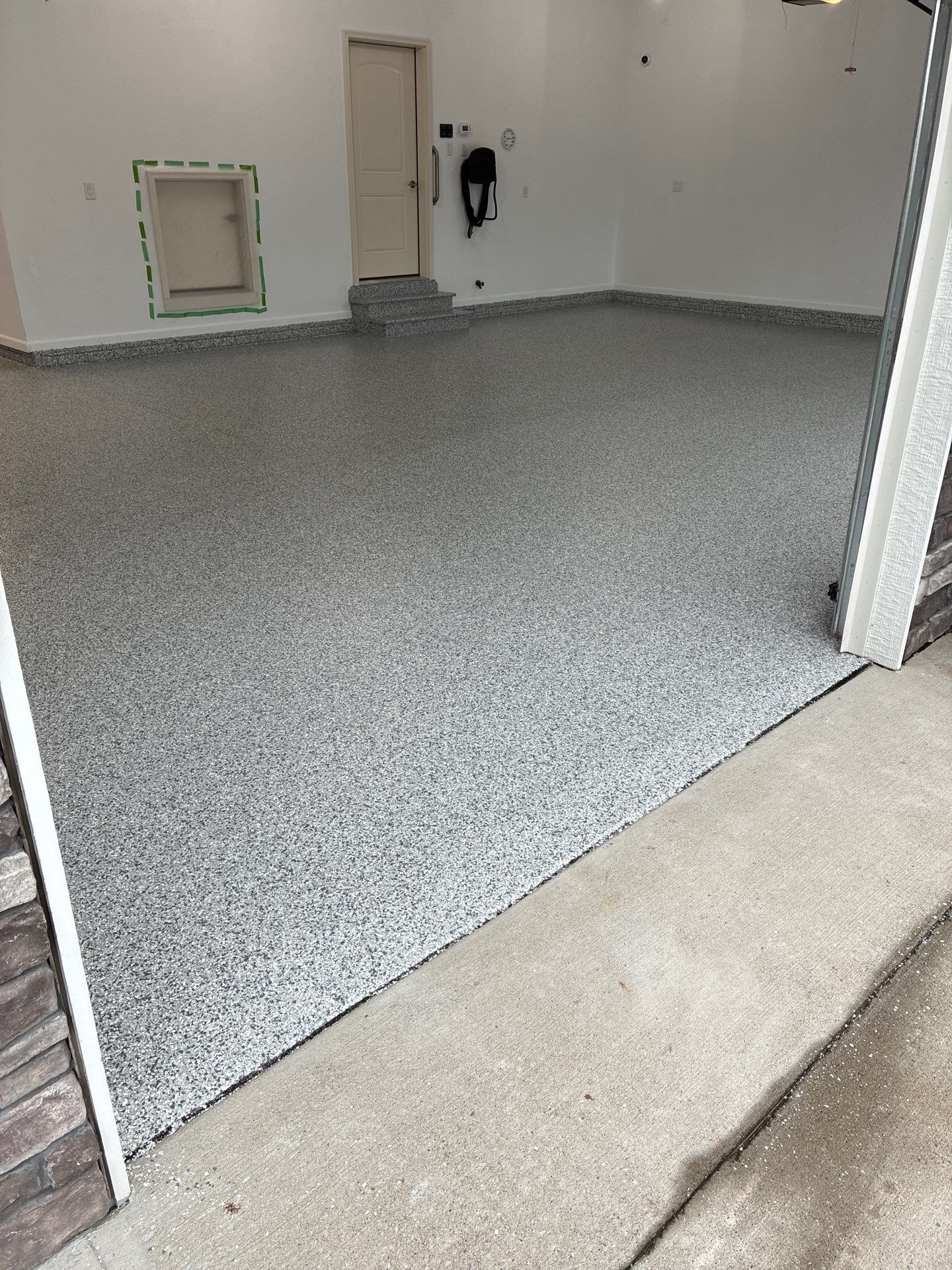 Gray Speckled Epoxy Garage Floor Coating in Grimes by Revival Concrete Coatings