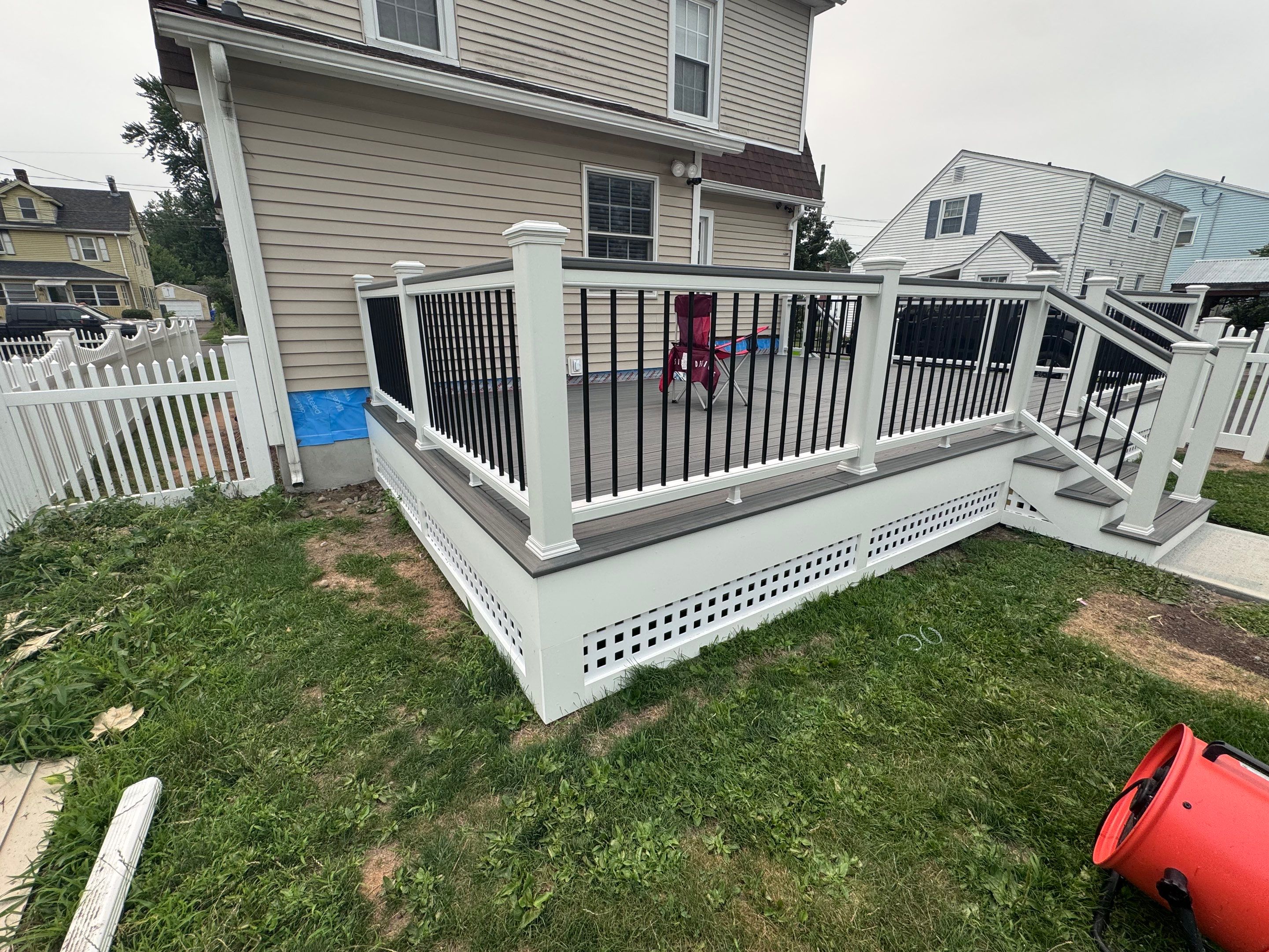 Deck Replacement usin gTrex Tropical Islandmist and Transcend Cocktail rail, Includes lattice and a gate. by DiGiorgi Roofing and Siding Inc